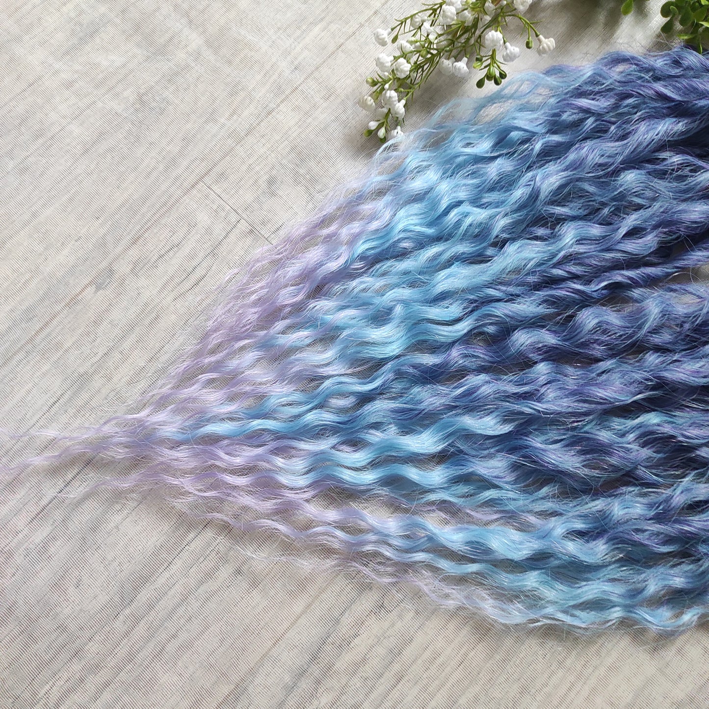 Soft, lightweight, and reusable synthetic sets of double ended regular curls (NOT BRUSHABLE) in blue and purple shades: ombre from indigo to sky blue and lavender.