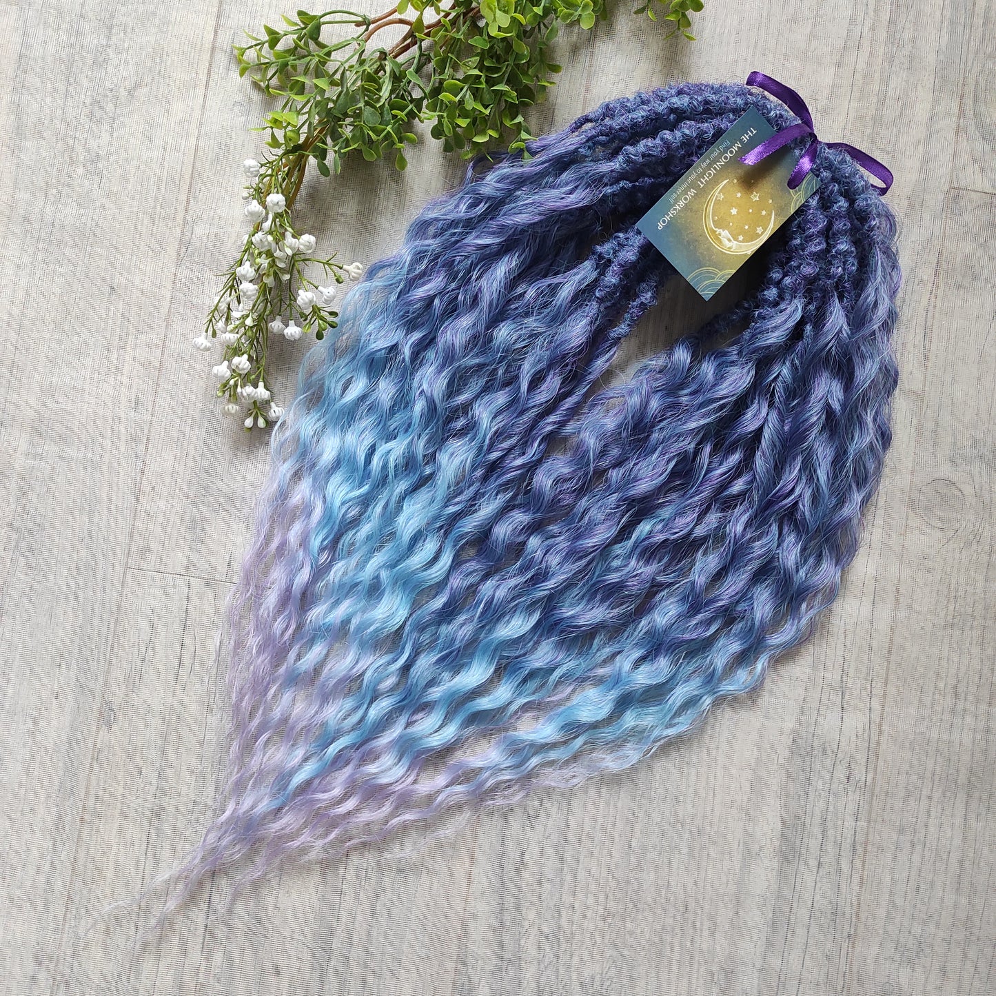 Soft, lightweight, and reusable synthetic sets of double ended regular curls (NOT BRUSHABLE) in blue and purple shades: ombre from indigo to sky blue and lavender.