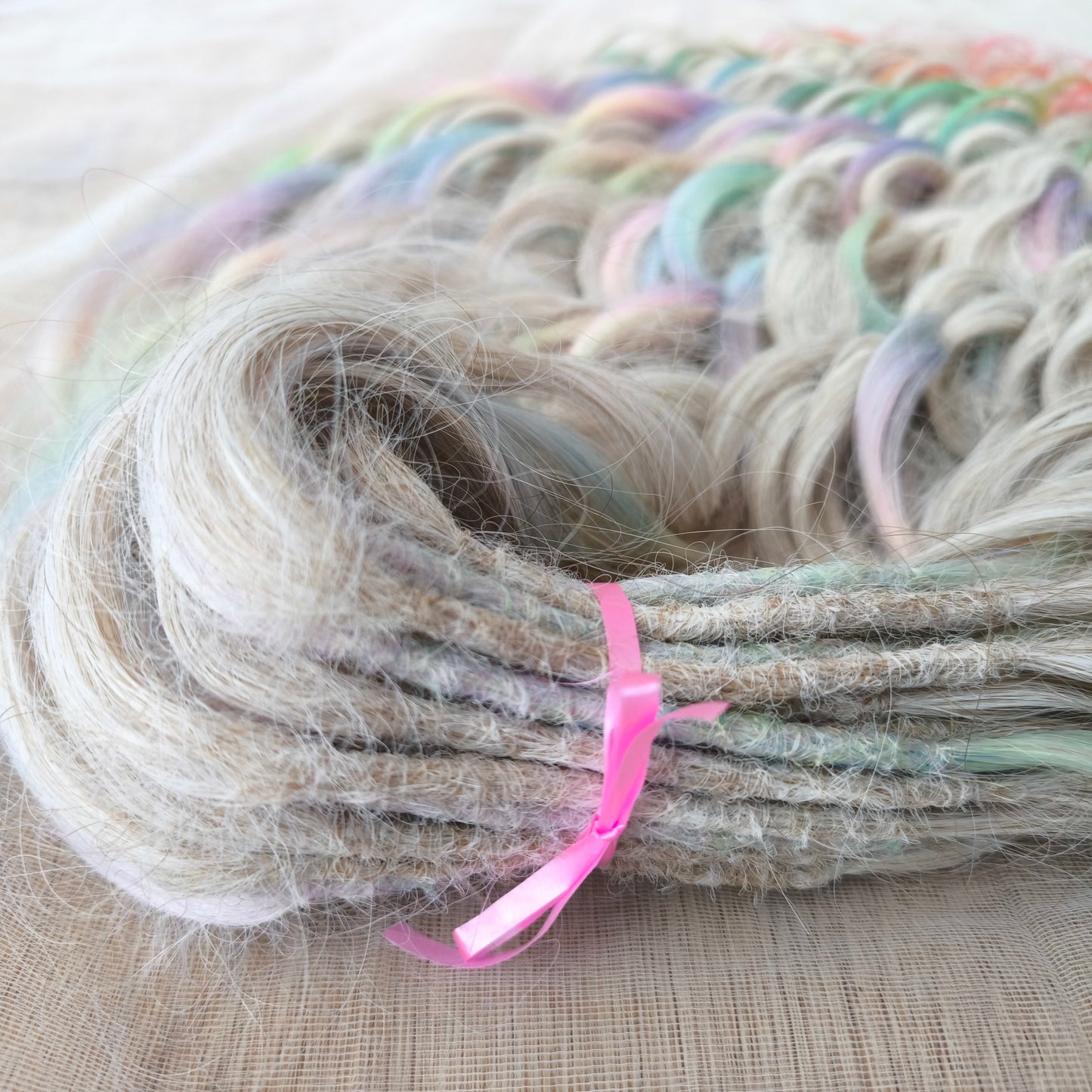 The mix of Platinum blonde and Rainbow/glitch/prism effect (2/3 parts of blonde + 1/3 part of rainbow) soft, lightweight, and reusable synthetic brushable double ended wavy dreadlocks (regular dreaded or push-up).