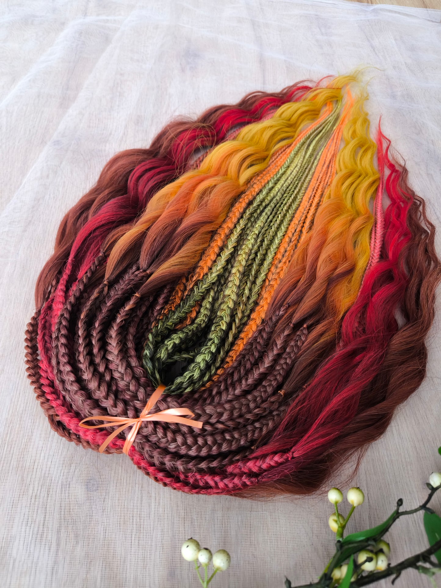 Mountain Sunrise: soft, lightweight, and reusable 55 double-ended synthetic braids with loose wavy brushable ends in red, bronze, yellow, and orange colors.