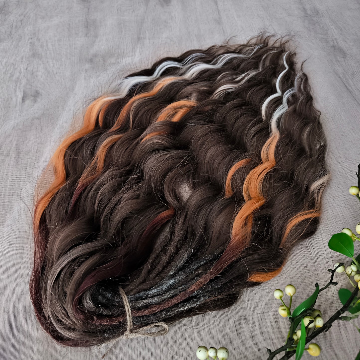 This moody, elegant set of soft, lightweight, and reusable synthetic brushable double-ended wavy dreadlocks features 2 shades of brown as the main color, enriched with calico strands.