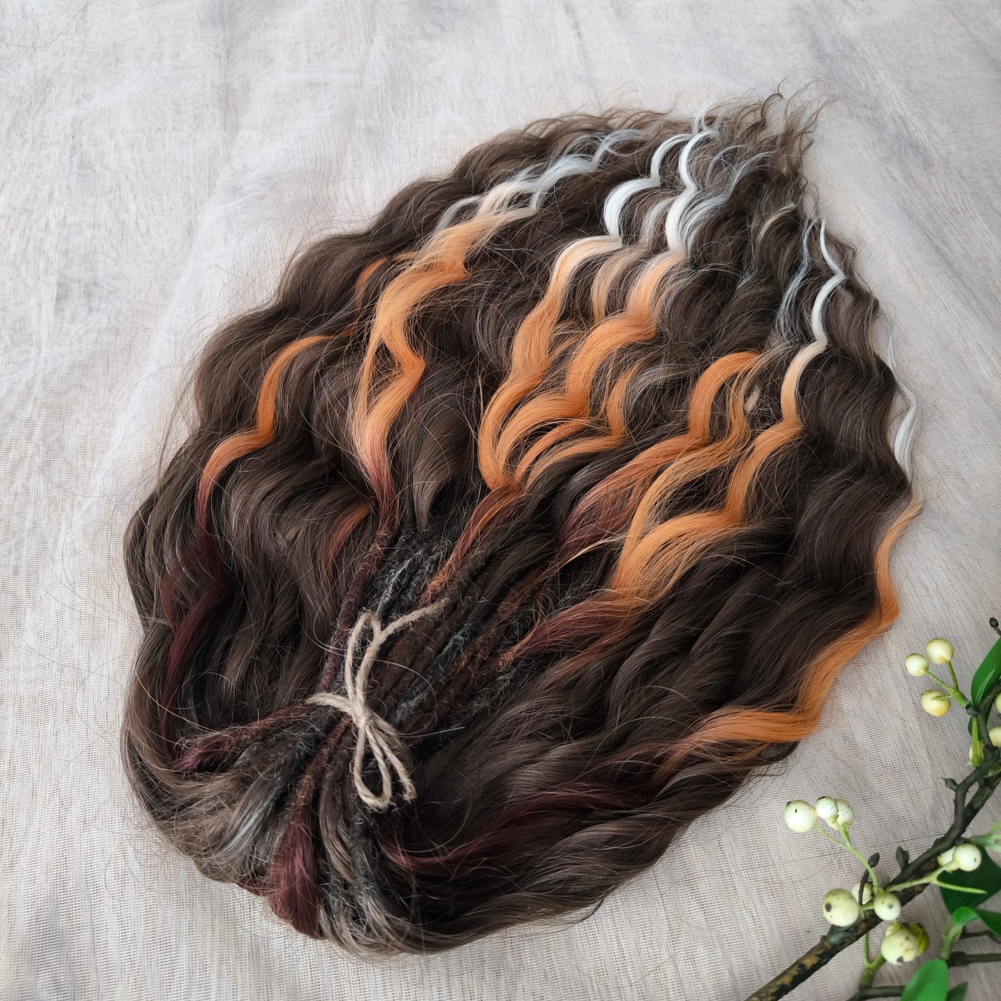 This moody, elegant set of soft, lightweight, and reusable synthetic brushable double-ended wavy dreadlocks features 2 shades of brown as the main color, enriched with calico strands.