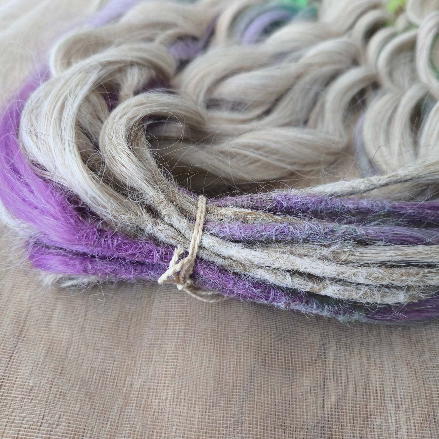 The mix of Platinum Blonde and Multicolored ombre from purple/lavender to light green and yellow soft, lightweight, and reusable synthetic brushable double ended wavy dreadlocks (regular dreaded or push-up): 2/3 parts of blonde + 1/3 part of rainbow