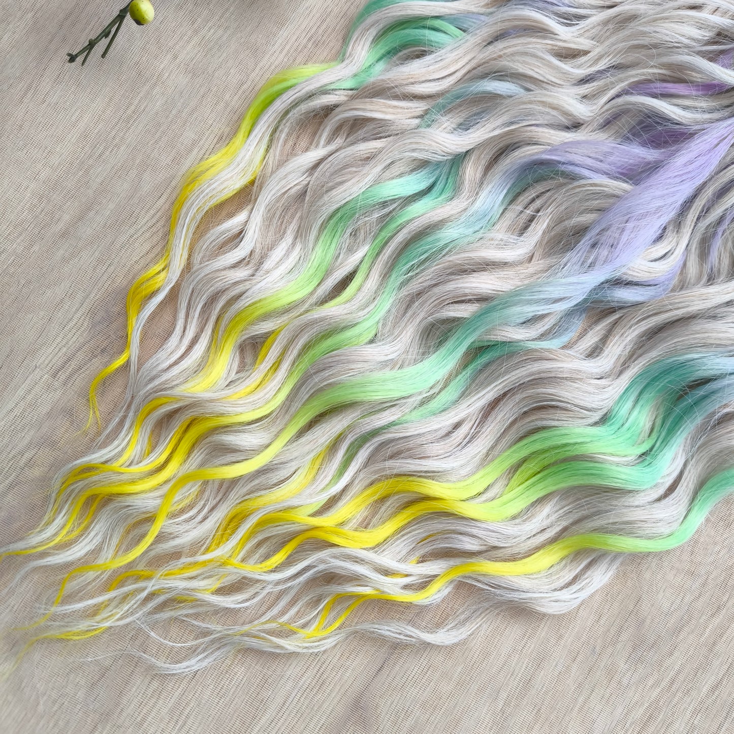 The mix of Platinum Blonde and Multicolored ombre from purple/lavender to light green and yellow soft, lightweight, and reusable synthetic brushable double ended wavy dreadlocks (regular dreaded or push-up): 2/3 parts of blonde + 1/3 part of rainbow