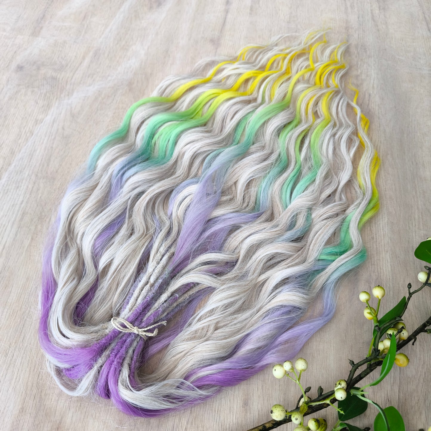 The mix of Platinum Blonde and Multicolored ombre from purple/lavender to light green and yellow soft, lightweight, and reusable synthetic brushable double ended wavy dreadlocks (regular dreaded or push-up): 2/3 parts of blonde + 1/3 part of rainbow