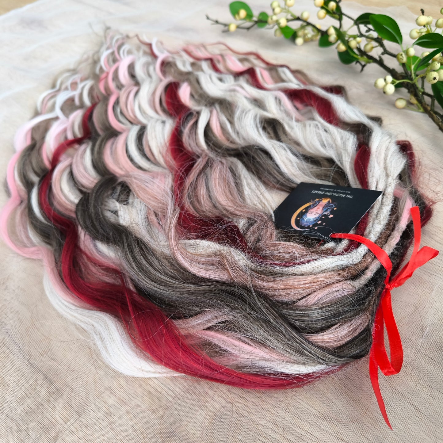 Soft, lightweight, and reusable synthetic brushable double ended wavy dreadlocks (regular dreaded or push-up). Mix of a few colors: platinum and ombre wheat blondes, various pink, and burgundy.