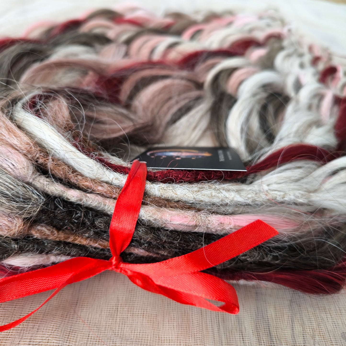 Soft, lightweight, and reusable synthetic brushable double ended wavy dreadlocks (regular dreaded or push-up). Mix of a few colors: platinum and ombre wheat blondes, various pink, and burgundy.