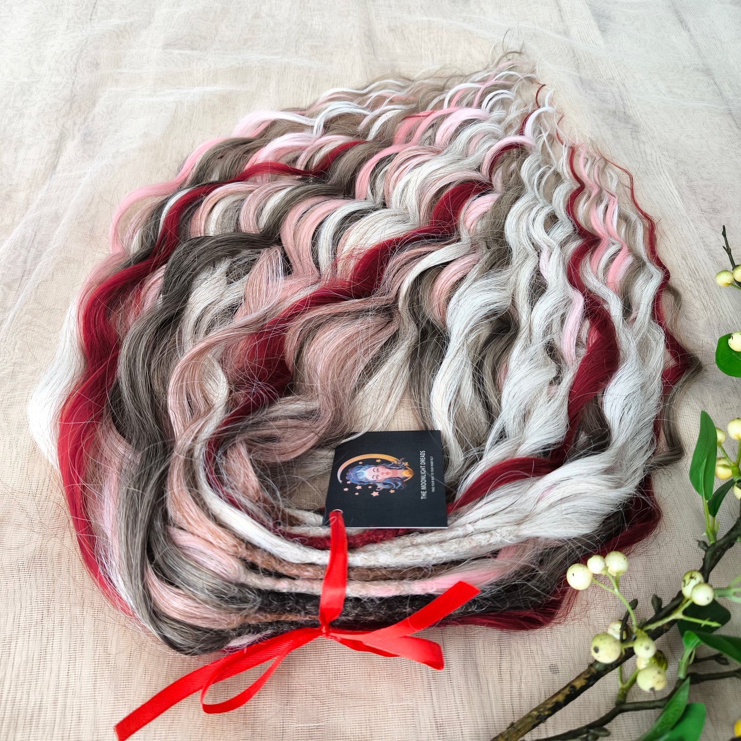 Soft, lightweight, and reusable synthetic brushable double ended wavy dreadlocks (regular dreaded or push-up). Mix of a few colors: platinum and ombre wheat blondes, various pink, and burgundy.