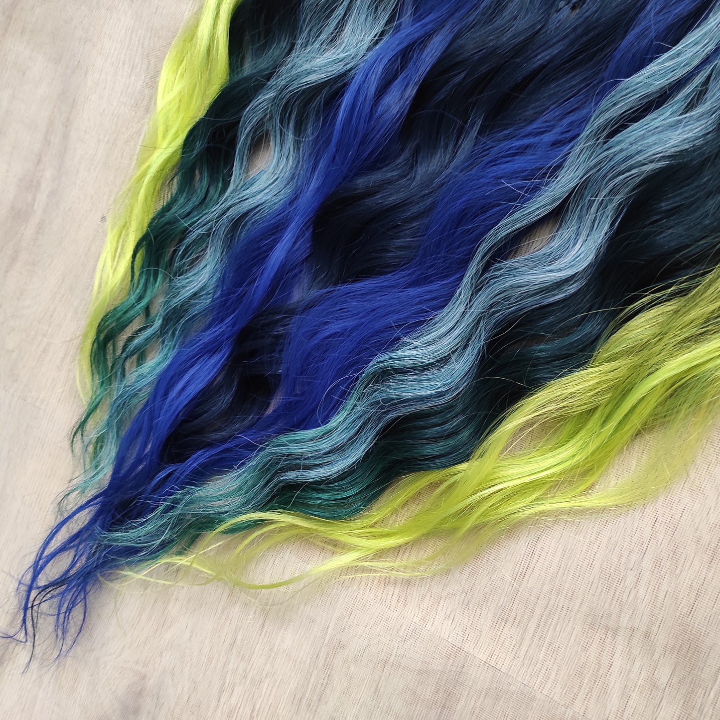Inspired by the feathers of a peacock and the magic of the deep forest, this set blends rich navy, electric blue, moss green, lime, and seafoam in an eye-catching gradient. Whether you're stepping into a festival or simply expressing your wild side, this look makes a powerful statement.
Soft, lightweight, and reusable synthetic brushable double ended wavy dreadlocks, a mix of Anna and Body wave with braided middle.