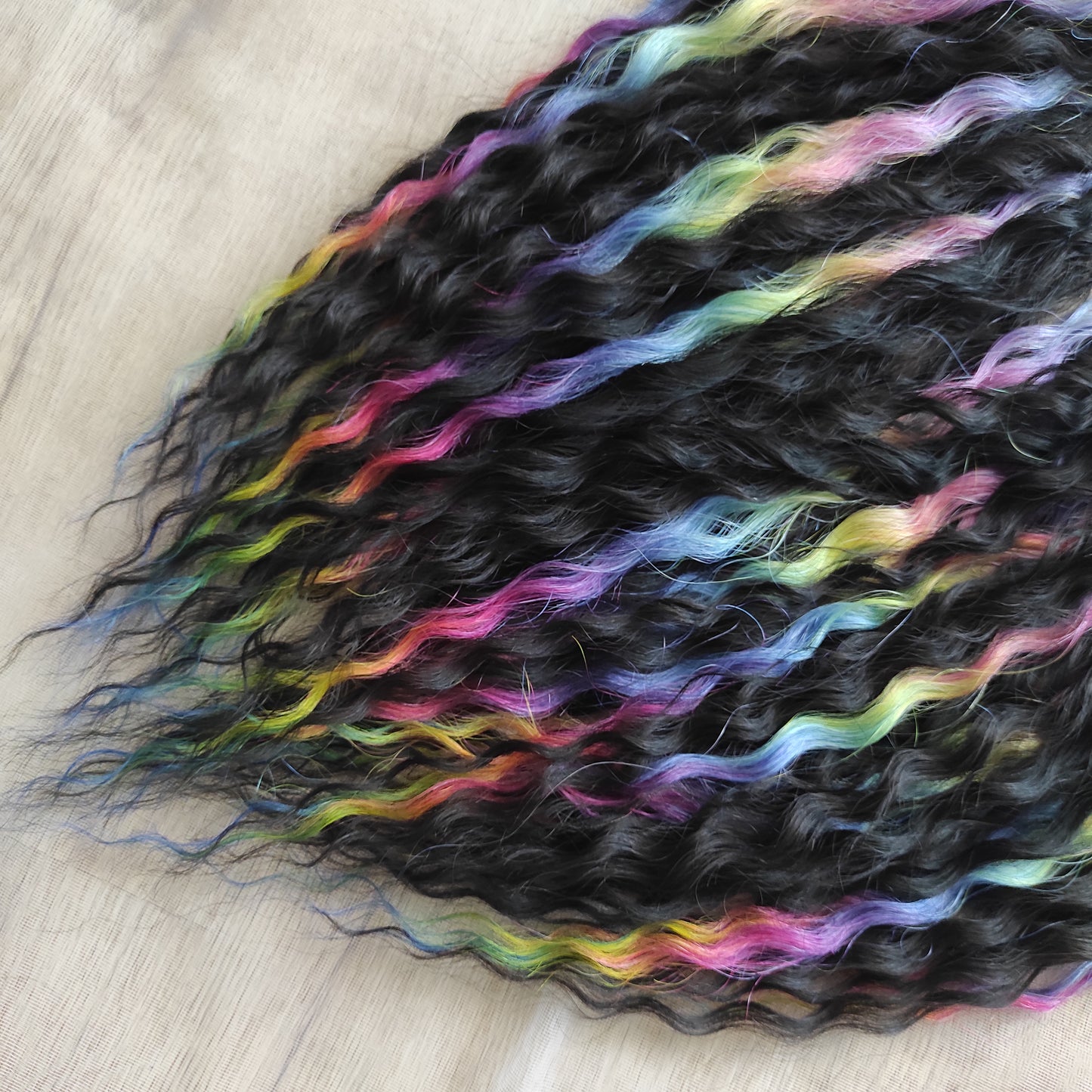 The mix of Black and Rainbow/glitch/prism effect soft, lightweight, and reusable synthetic brushable double ended wavy dreadlocks (NOT BRUSHABLE).