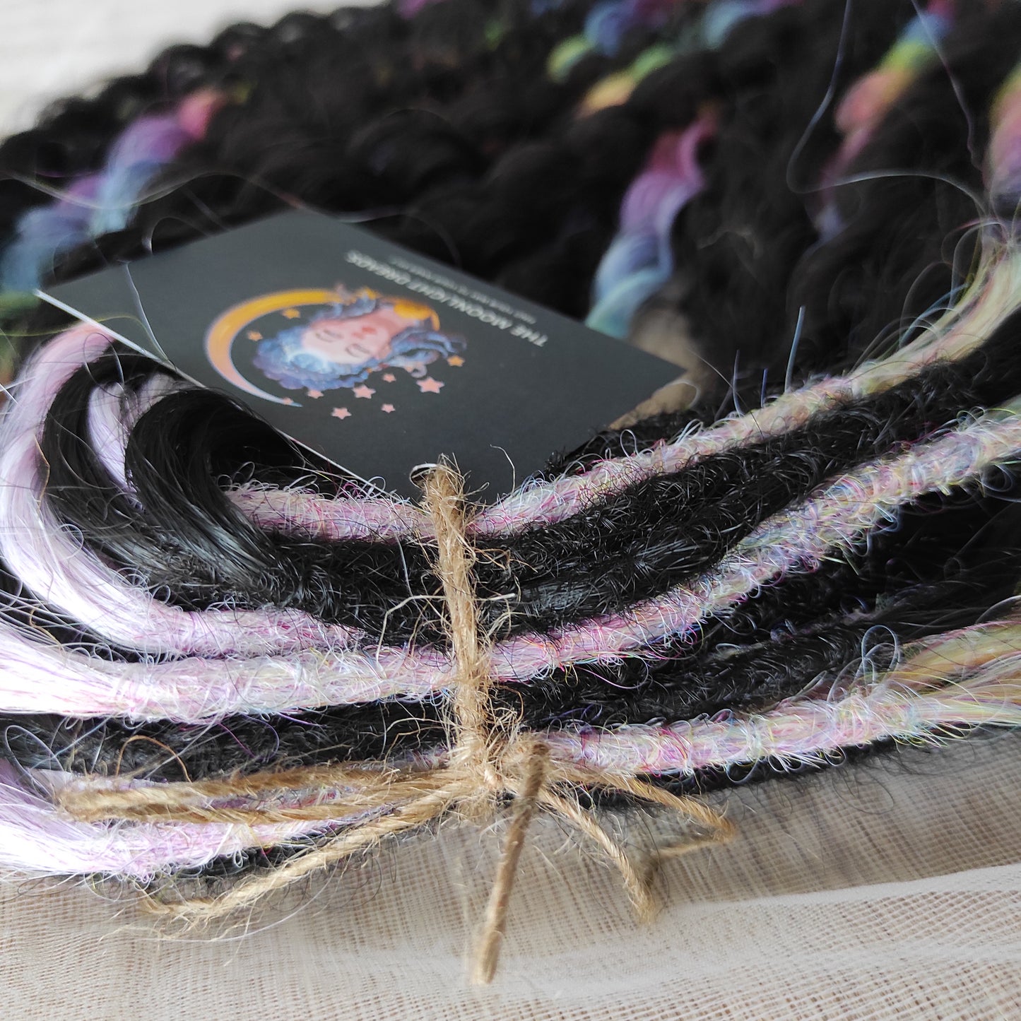 The mix of Black and Rainbow/glitch/prism effect soft, lightweight, and reusable synthetic brushable double ended wavy dreadlocks (NOT BRUSHABLE).