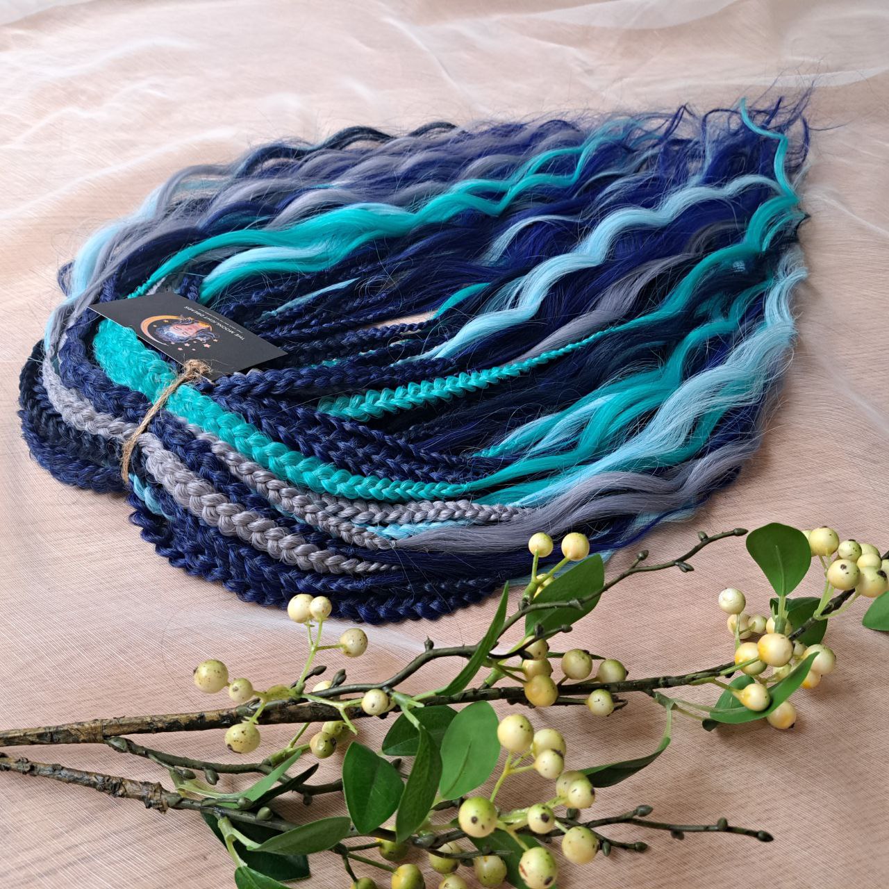 Dive into the deep with Ocean Storm - a powerful mix of midnight and navy blue, turquoise, teal, and icy silver that flows like wild ocean waves. Bold, refreshing, and mysterious - this set is perfect for those who love dramatic contrasts and want their look to stand out.
Soft, lightweight, and reusable custom synthetic brushable double ended curls, a mix of Anna and Body wave (regular dreaded, braided middle or push-up).