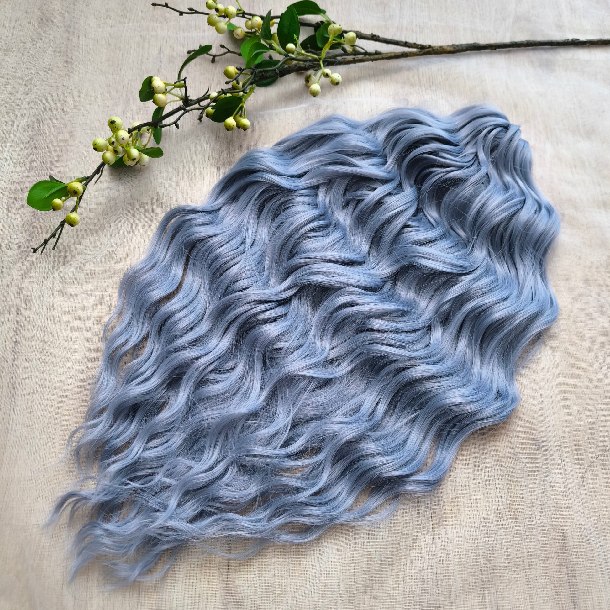 Frost Grey (steel blue) is a calm, elegant blend of silver and soft grey tones with a subtle lavender undertone. It reflects light beautifully, creating a silky, frosted look that feels both minimalistic and mystical. Soft, lightweight, and reusable synthetic brushable double ended wavy dreadlocks (regular dreaded, braided middle, or push-up). 