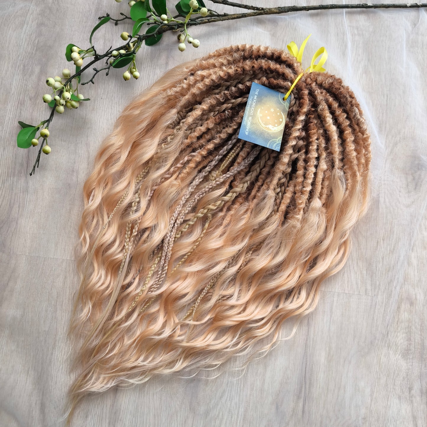 Soft, lightweight, and reusable synthetic brushable double ended wavy dreadlocks. The base starts with a warm chocolate chestnut at the roots, blending seamlessly into a sandy honey blonde with subtle creamy peach undertones.