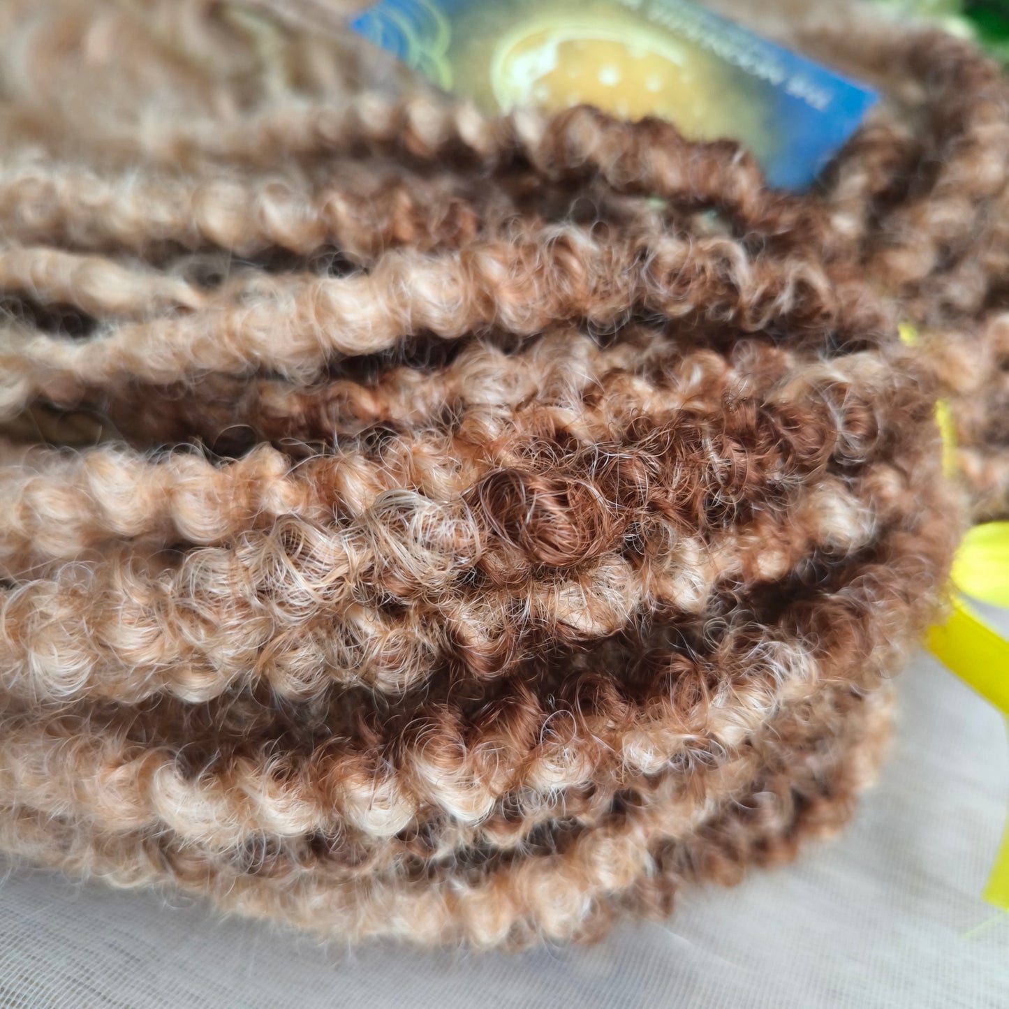 Soft, lightweight, and reusable synthetic brushable double ended wavy dreadlocks. The base starts with a warm chocolate chestnut at the roots, blending seamlessly into a sandy honey blonde with subtle creamy peach undertones.