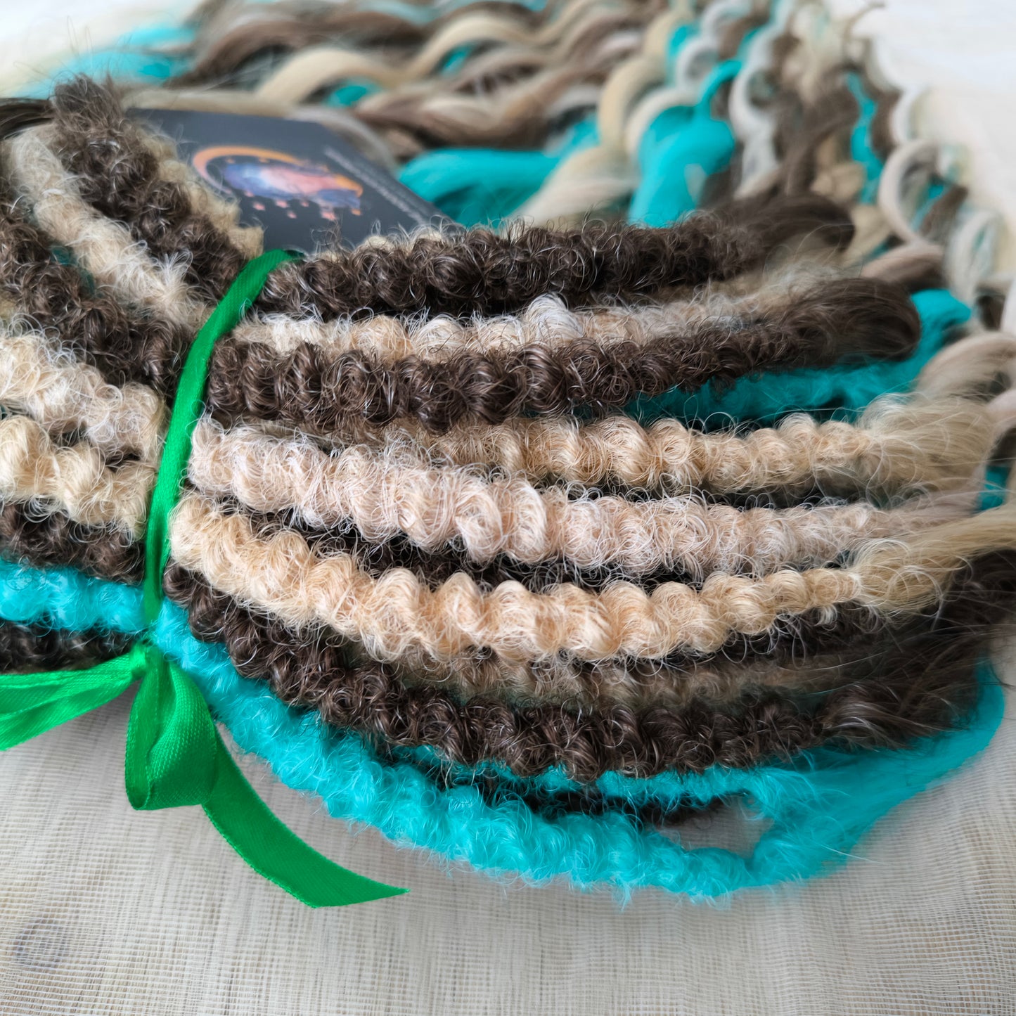 Brown, 2 shades of blonde, and turquoise green soft, lightweight, and reusable synthetic brushable double-ended wavy dreadlocks (regular dreaded or push-up)