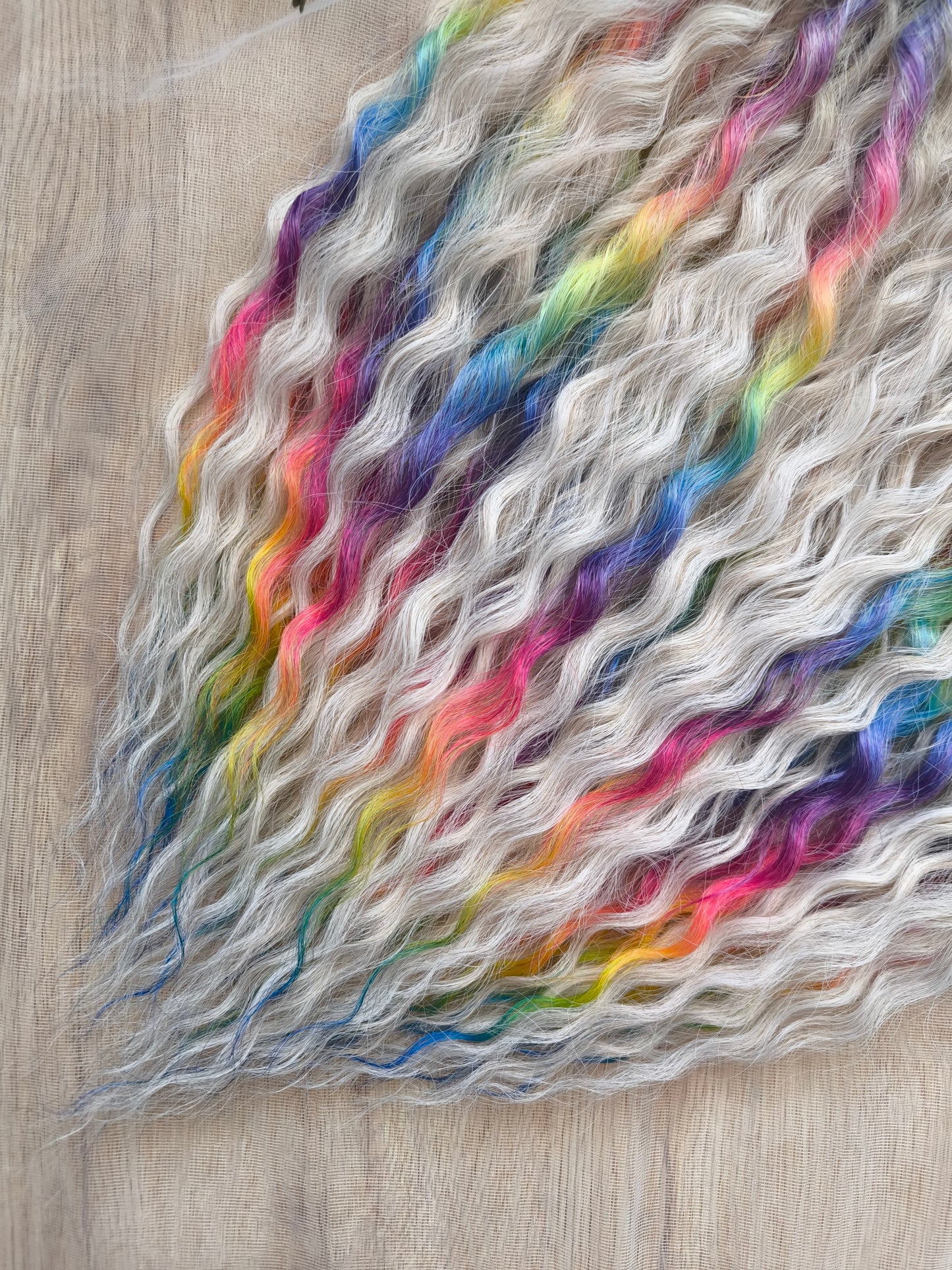 White Rainbow: the mix of Platinum Blonde (2/3 parts of blonde) + and Rainbow/glitch/prism effect (1/3 part of rainbow) soft, lightweight, and reusable synthetic brushable double ended wavy dreadlocks (NOT BRUSHABLE).