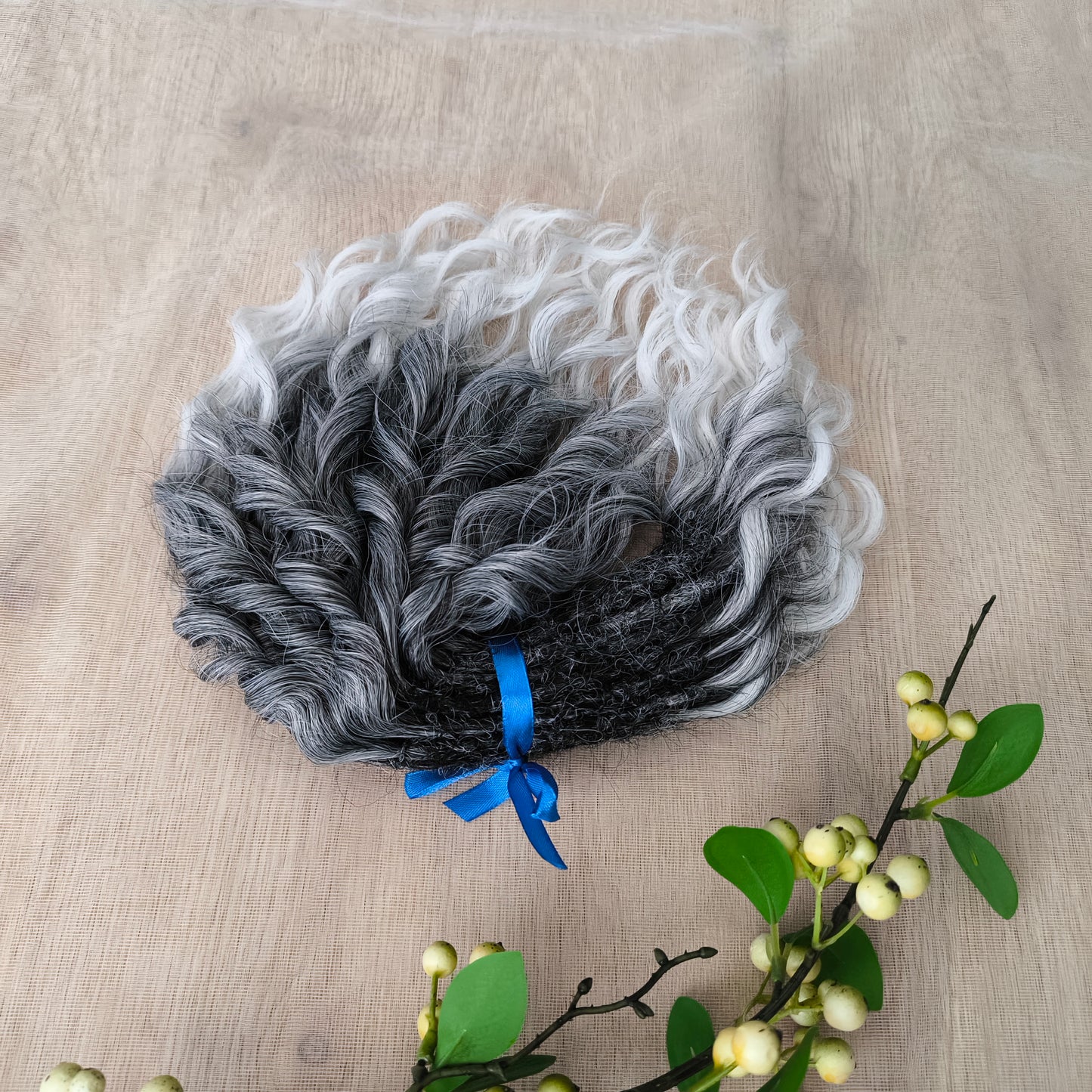Salt and pepper: ombre from dark grey to white, natural-looking, short Jessica regular dreaded curls. The length is 10 inches (25 cm), dreaded part ±3-4 inches.