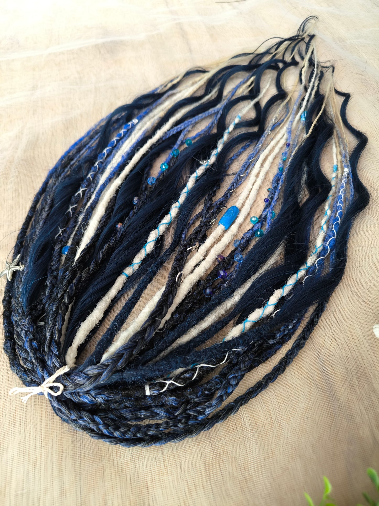 Deep blue see — navy blue, obmbre blue to blonde, and white partial set of 28 double ended synthetic dreadlocks, various braids, Senegalese twist, and brushable dreaded curls (decoration is included). Reusable lightweight set made from high-quality synthetic hypoallergenic material kanekalon.
Length: ±20-24 inches (50-60 cm)
Thickness of dreads and braids: ±0.6-0.8 cm
Dreaded part of curls ±3-4 inches (8-10 cm)
Weight with decoration: ±175 gr (6 oz)