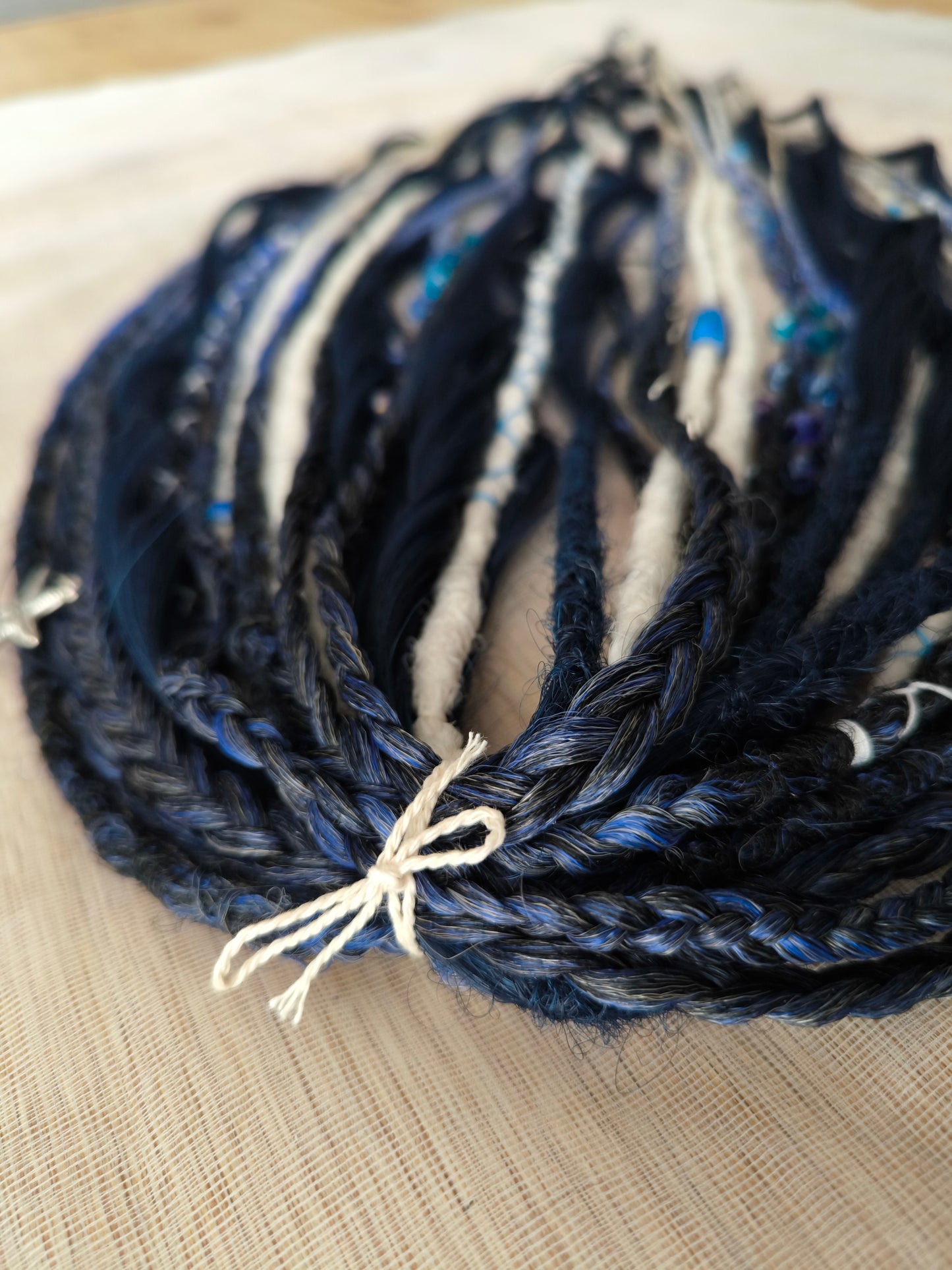 Deep blue see — navy blue, obmbre blue to blonde, and white partial set of 28 double ended synthetic dreadlocks, various braids, Senegalese twist, and brushable dreaded curls (decoration is included). Reusable lightweight set made from high-quality synthetic hypoallergenic material kanekalon.
Length: ±20-24 inches (50-60 cm)
Thickness of dreads and braids: ±0.6-0.8 cm
Dreaded part of curls ±3-4 inches (8-10 cm)
Weight with decoration: ±175 gr (6 oz)