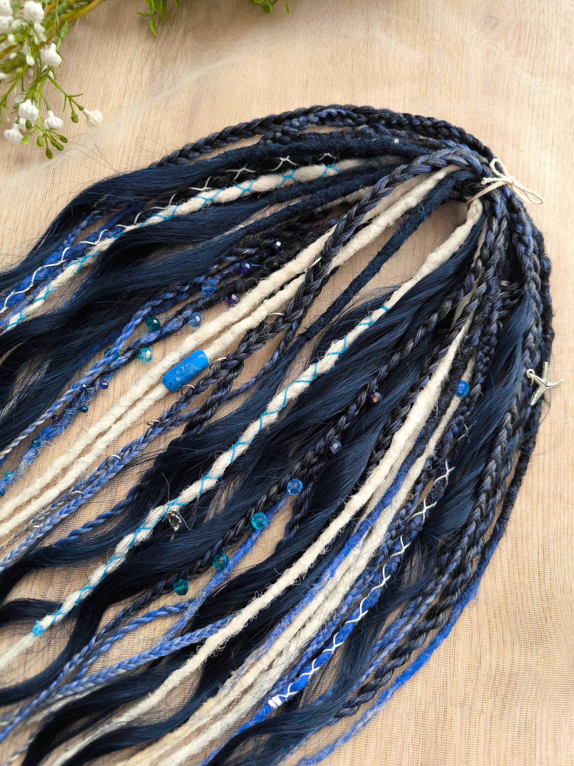 Deep blue see — navy blue, obmbre blue to blonde, and white partial set of 28 double ended synthetic dreadlocks, various braids, Senegalese twist, and brushable dreaded curls (decoration is included). Reusable lightweight set made from high-quality synthetic hypoallergenic material kanekalon.
Length: ±20-24 inches (50-60 cm)
Thickness of dreads and braids: ±0.6-0.8 cm
Dreaded part of curls ±3-4 inches (8-10 cm)
Weight with decoration: ±175 gr (6 oz)