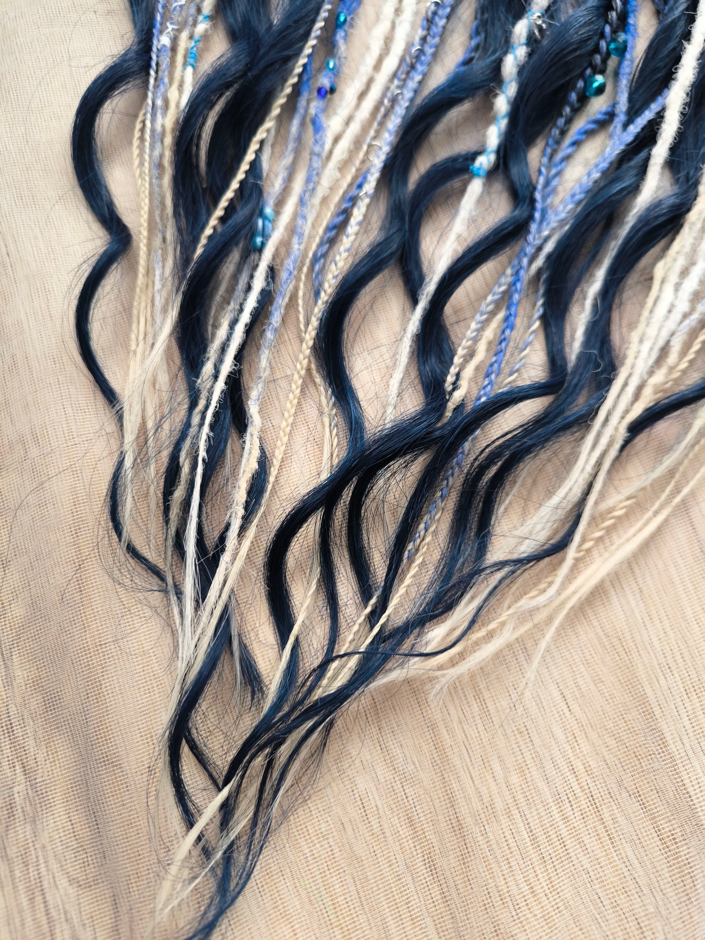 Deep blue see — navy blue, obmbre blue to blonde, and white partial set of 28 double ended synthetic dreadlocks, various braids, Senegalese twist, and brushable dreaded curls (decoration is included). Reusable lightweight set made from high-quality synthetic hypoallergenic material kanekalon.
Length: ±20-24 inches (50-60 cm)
Thickness of dreads and braids: ±0.6-0.8 cm
Dreaded part of curls ±3-4 inches (8-10 cm)
Weight with decoration: ±175 gr (6 oz)