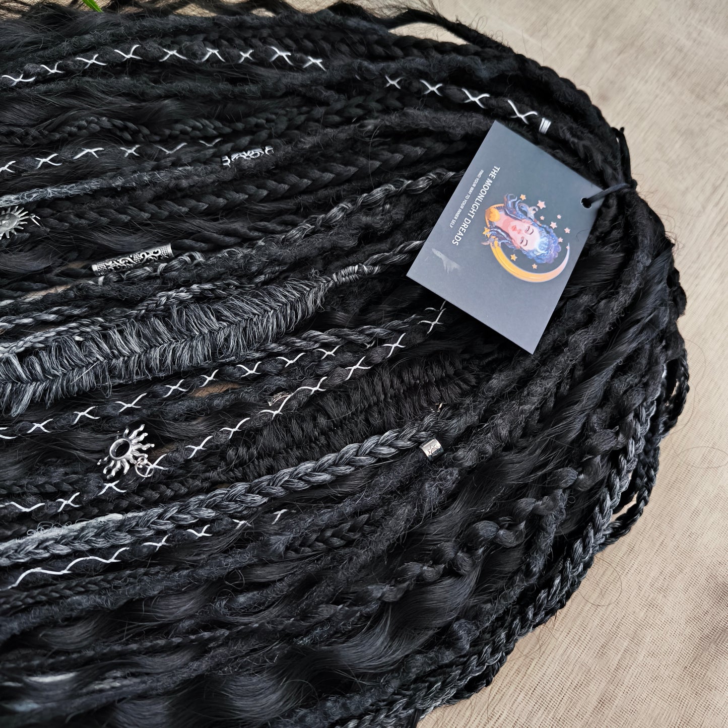 Pagan Witch — black, gray, and white/blonde set of 55 double ended synthetic bumpy dreads, braids, Senegalese twist, and dreaded curls (decoration is included). Reusable lightweight set made from high-quality synthetic hypoallergenic material kanekalon.
Standard length: ±22-24 inches (55-60 cm)
Thickness of dreads and braids: ±0.6-0.8 cm
Dreaded part of curls ±3-4 inches (8-10 cm)
Weight with decoration: ±310 gr (11 oz)
