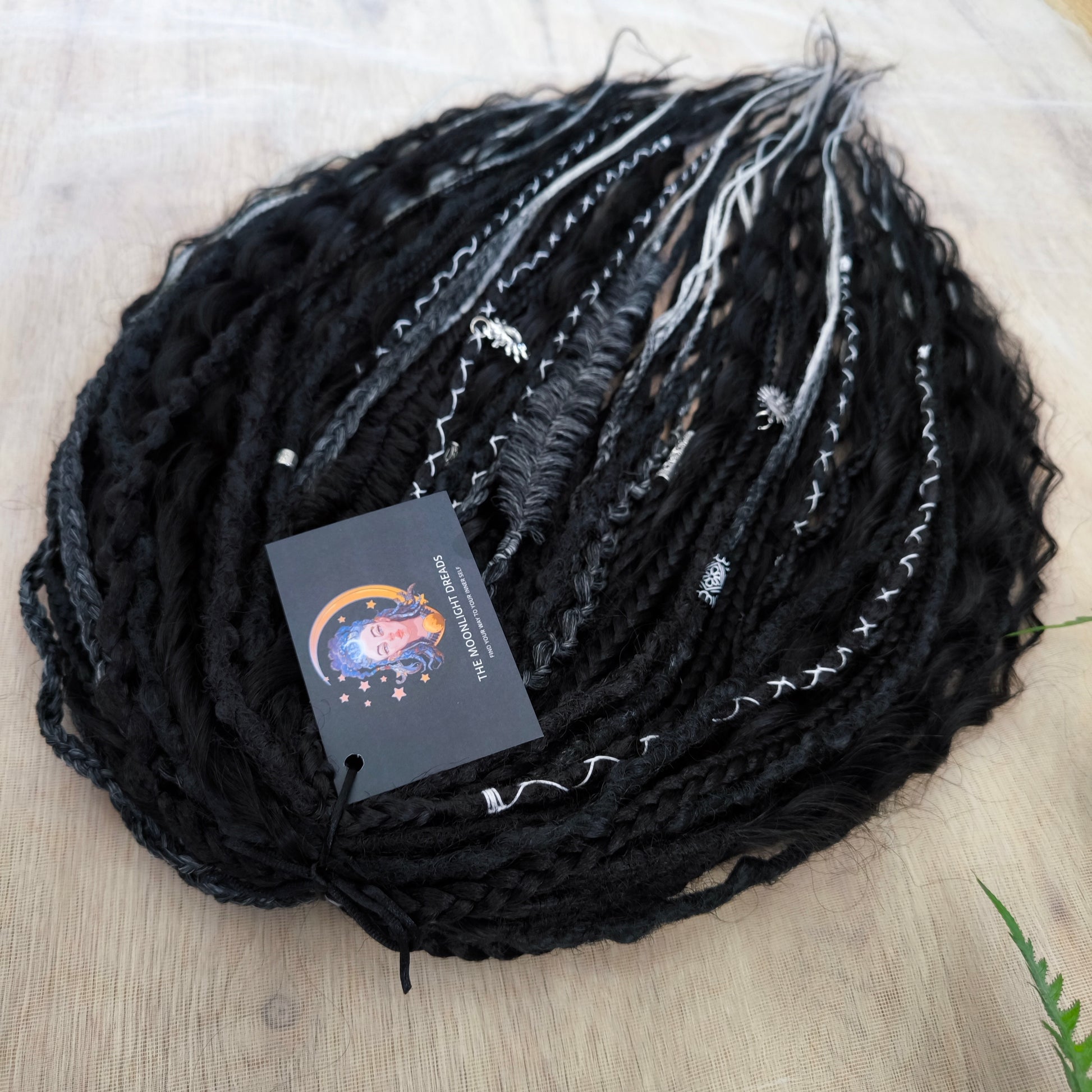 Pagan Witch — black, gray, and white/blonde set of 55 double ended synthetic bumpy dreads, braids, Senegalese twist, and dreaded curls (decoration is included). Reusable lightweight set made from high-quality synthetic hypoallergenic material kanekalon.
Standard length: ±22-24 inches (55-60 cm)
Thickness of dreads and braids: ±0.6-0.8 cm
Dreaded part of curls ±3-4 inches (8-10 cm)
Weight with decoration: ±310 gr (11 oz)