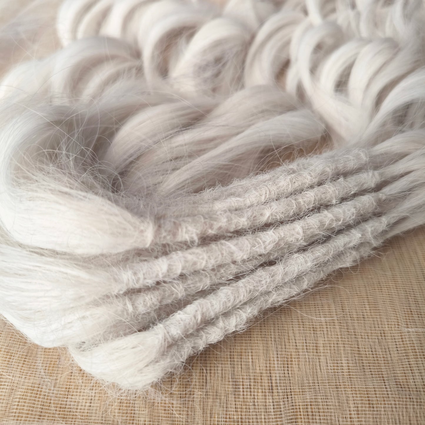 Snow-white soft, lightweight, and reusable synthetic brushable double ended wavy dreadlocks (regular dreaded, braided middle, or push-up).