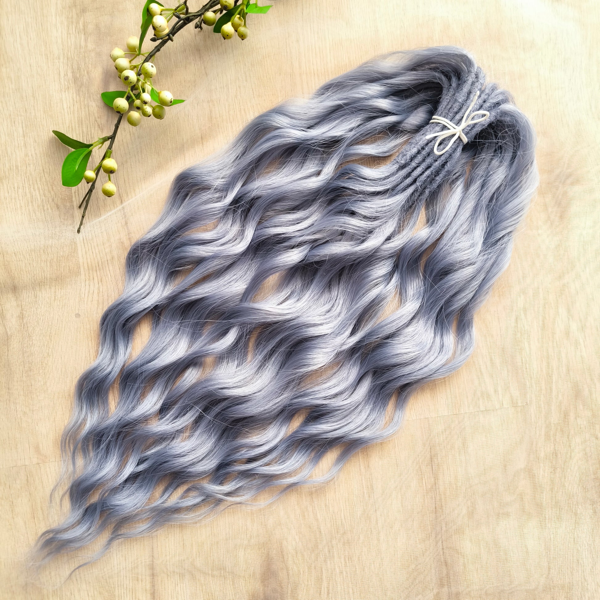 Frost Grey (steel blue) is a calm, elegant blend of silver and soft grey tones with a subtle lavender undertone. It reflects light beautifully, creating a silky, frosted look that feels both minimalistic and mystical. Soft, lightweight, and reusable synthetic brushable double ended wavy dreadlocks (regular dreaded, braided middle, or push-up). 