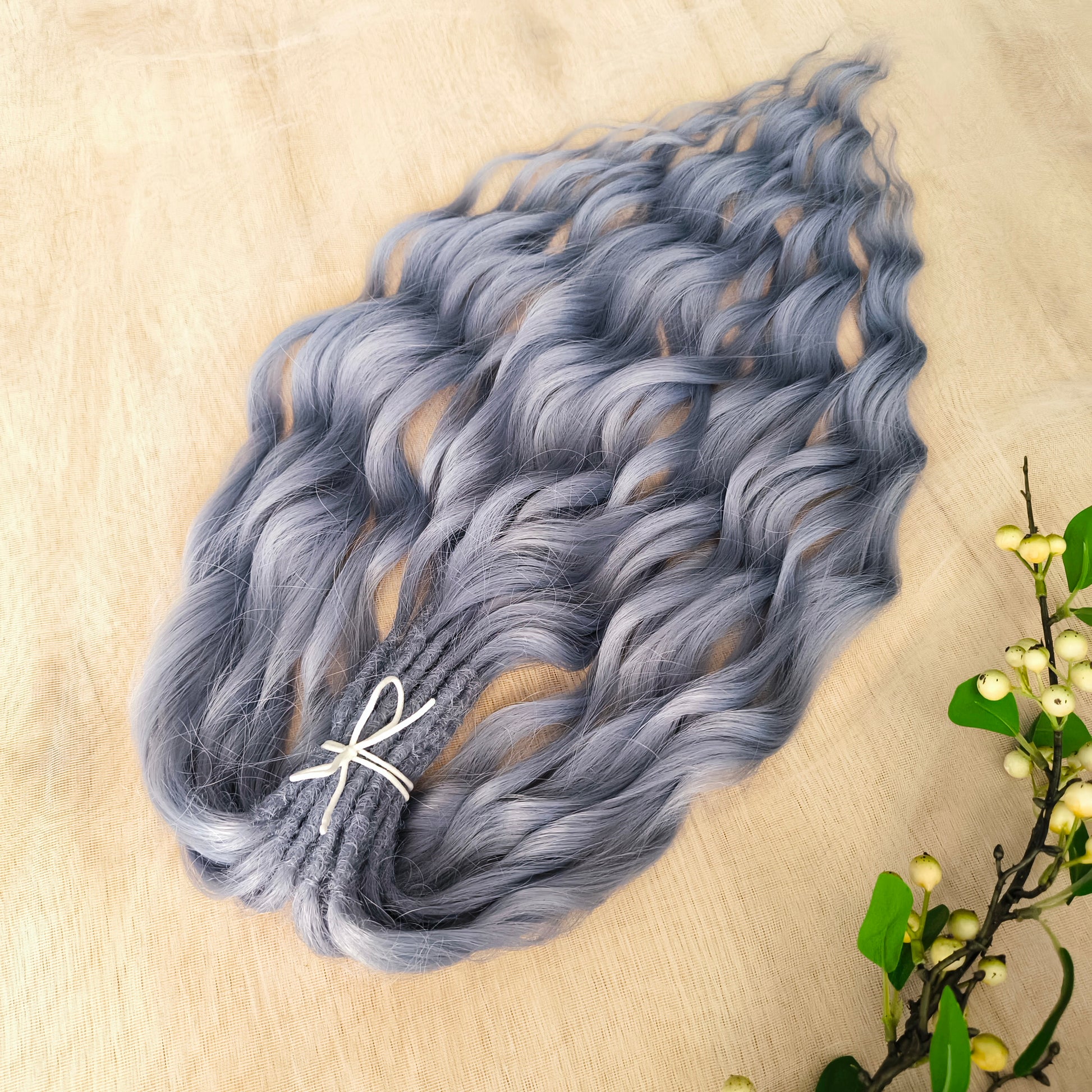 Frost Grey (steel blue) is a calm, elegant blend of silver and soft grey tones with a subtle lavender undertone. It reflects light beautifully, creating a silky, frosted look that feels both minimalistic and mystical. Soft, lightweight, and reusable synthetic brushable double ended wavy dreadlocks (regular dreaded, braided middle, or push-up). 