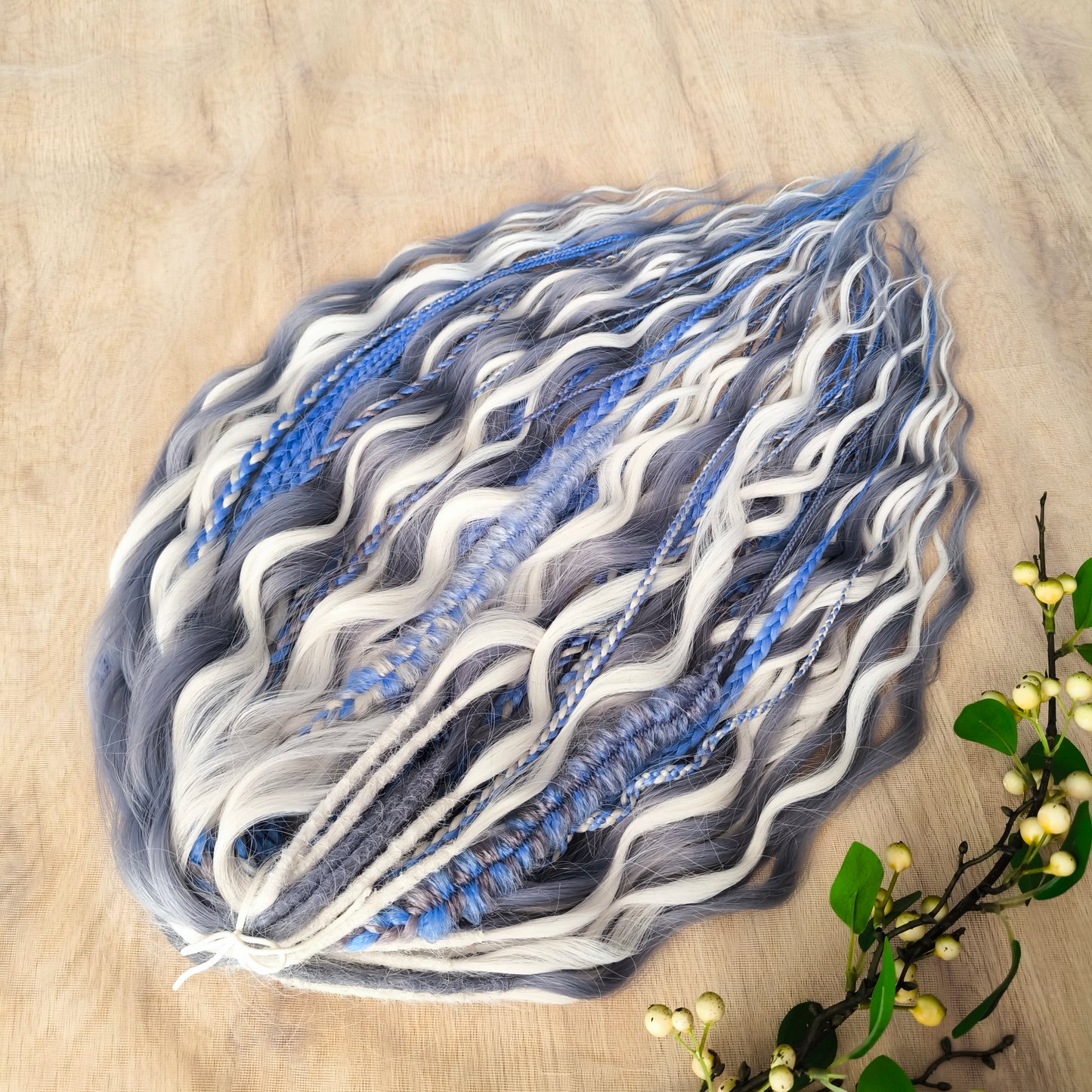 Arctic Ice: soft, lightweight, and reusable 60 double ended various synthetic braids, Senegalese twists, and brushable regular dreaded curls. A mix of white, sky blue and steel blue colours.
The length is 22-24 inches (55-60 cm)
Dreaded part of curls: 3-4 inches (8-10 cm)
Thickness of braids ±0.8 cm