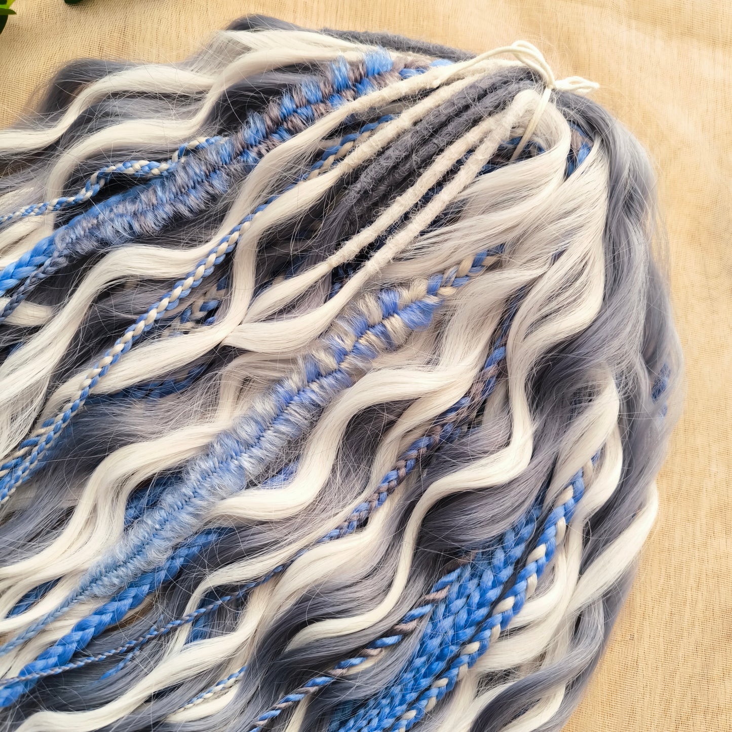 Arctic Ice: soft, lightweight, and reusable 60 double ended various synthetic braids, Senegalese twists, and brushable regular dreaded curls. A mix of white, sky blue and steel blue colours.
The length is 22-24 inches (55-60 cm)
Dreaded part of curls: 3-4 inches (8-10 cm)
Thickness of braids ±0.8 cm