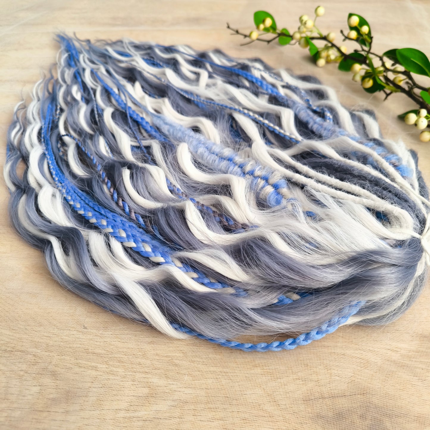 Arctic Ice: soft, lightweight, and reusable 60 double ended various synthetic braids, Senegalese twists, and brushable regular dreaded curls. A mix of white, sky blue and steel blue colours.
The length is 22-24 inches (55-60 cm)
Dreaded part of curls: 3-4 inches (8-10 cm)
Thickness of braids ±0.8 cm