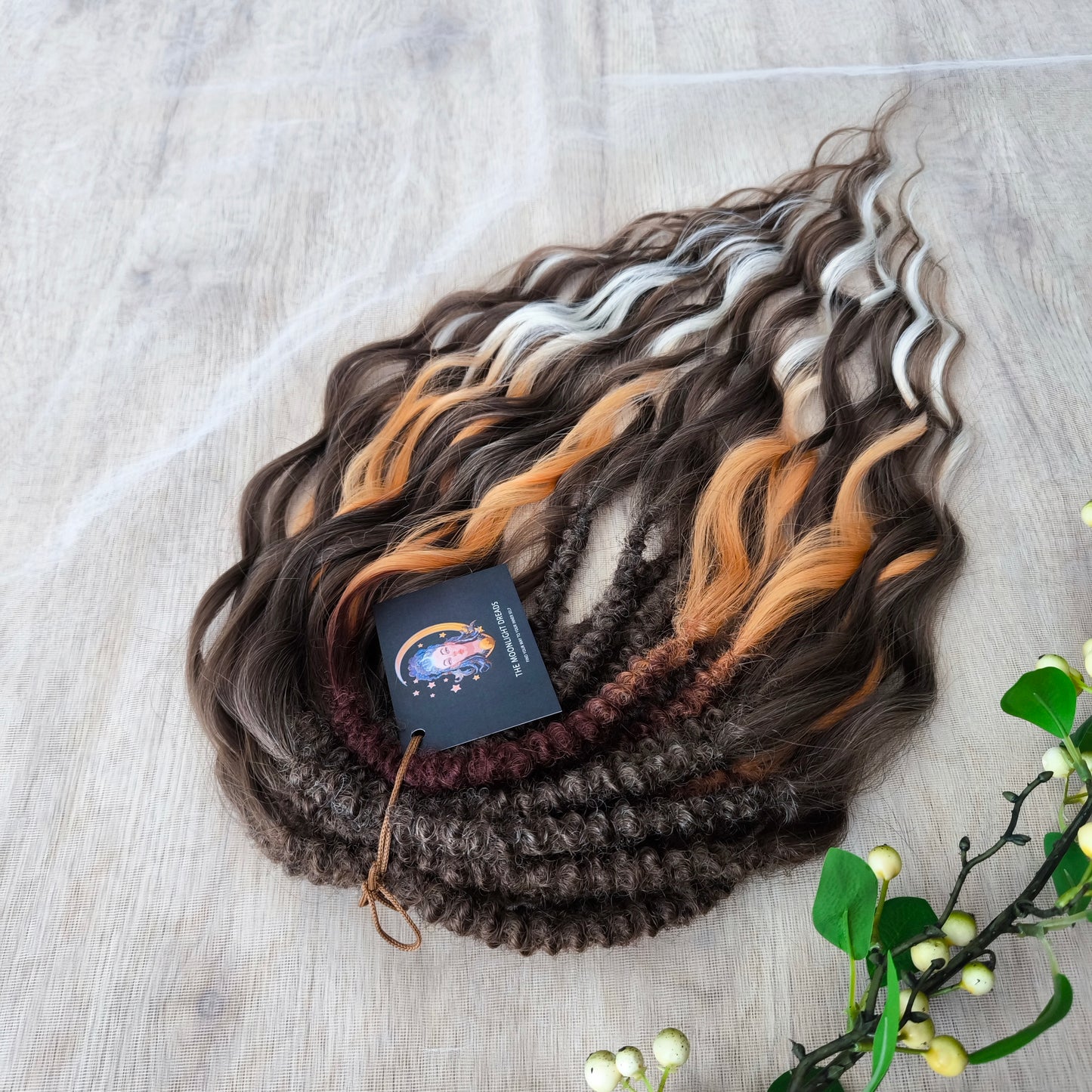 This moody, elegant set of soft, lightweight, and reusable synthetic brushable double-ended wavy dreadlocks features 2 shades of brown as the main color, enriched with calico strands.