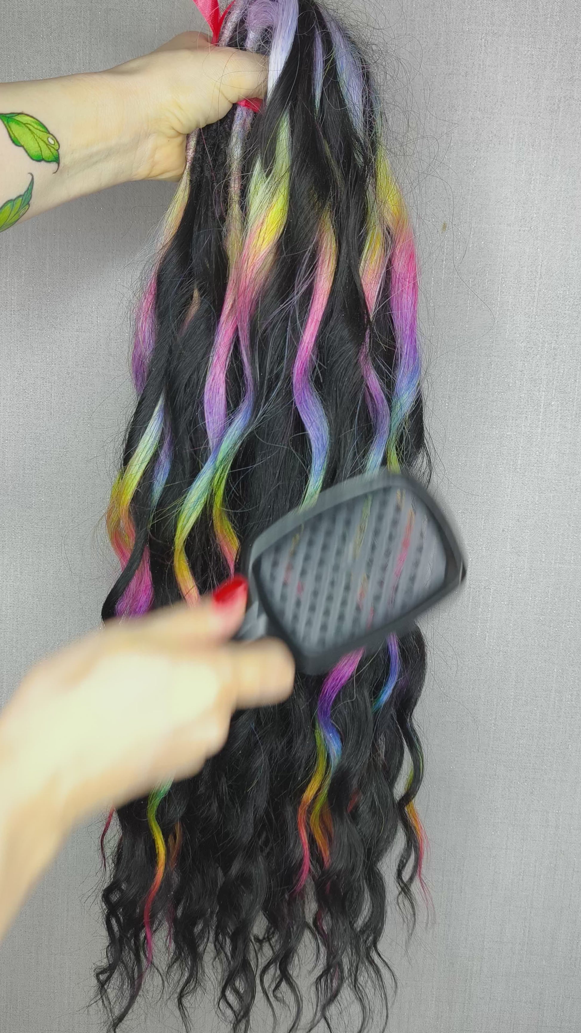 The mix of Black and Rainbow/glitch/prism effect (2/3 parts of black + 1/3 part of rainbow) soft, lightweight, and reusable synthetic brushable double ended wavy dreadlocks.