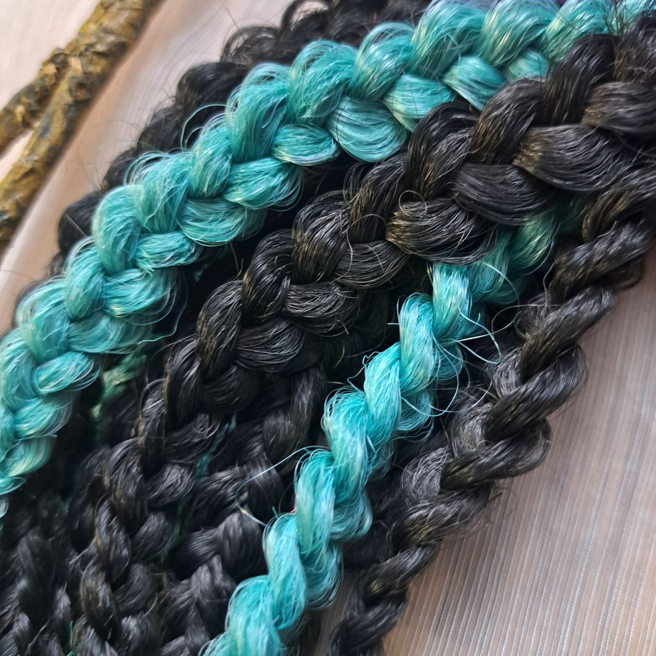The mix of Black and ombre from green to purple and red soft, lightweight, and reusable synthetic brushable double ended wavy dreadlocks (braided middle): 2/3 parts of black + 1/3 part of rainbow