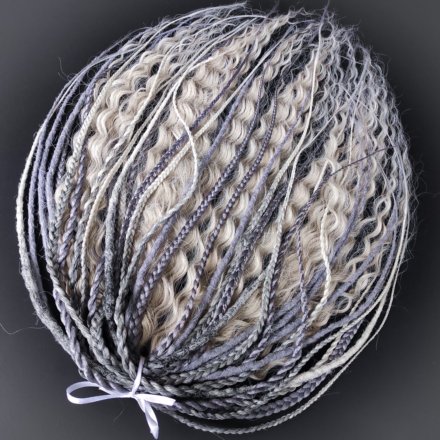 A mix of silver, grey and blonde - lightweight,  reusable synthetic double ended crochet dreadlocks, non-brushable dreaded curls, braids, and Senegalese twists.

Standard length: ±22-24 inches (55-60 cm)
Thickness of dreads and braids: ±0.8 cm
Dreaded part of curls ±10-12 cm (4-5 inches)