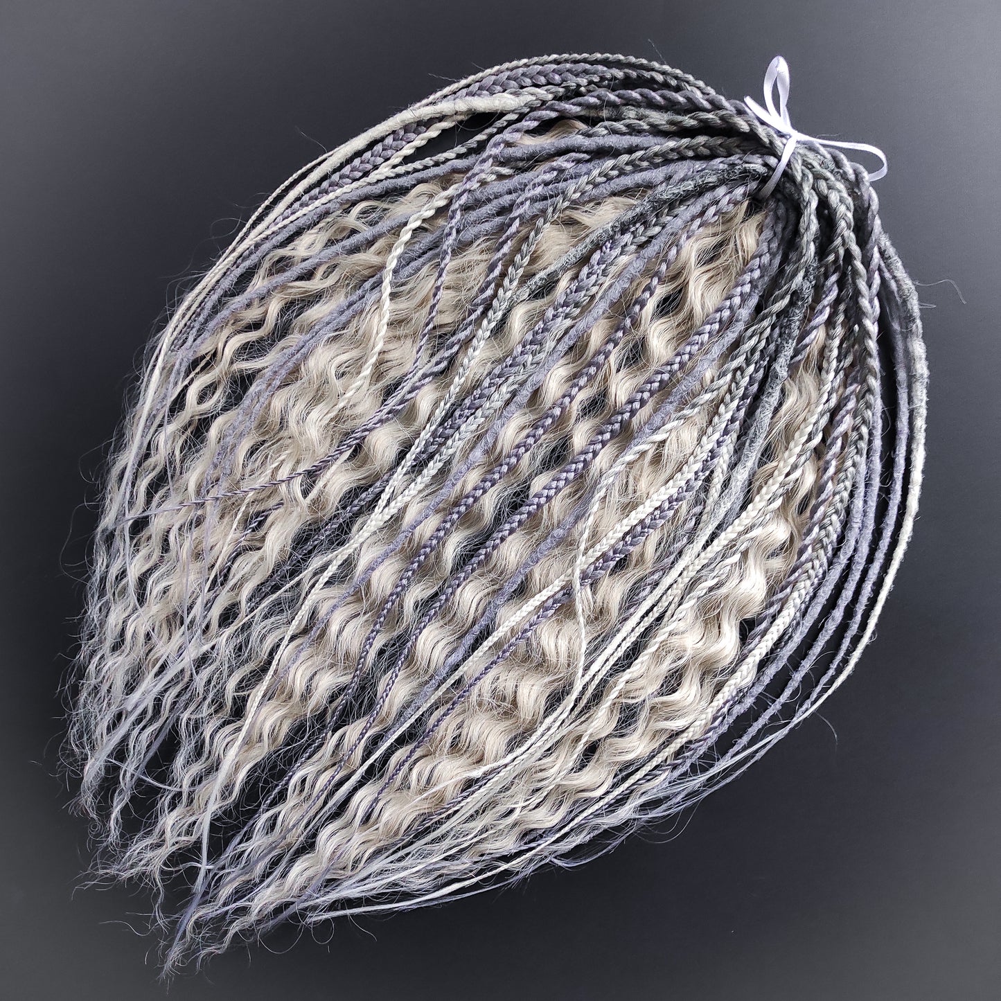 A mix of silver, grey and blonde - lightweight,  reusable synthetic double ended crochet dreadlocks, non-brushable dreaded curls, braids, and Senegalese twists.

Standard length: ±22-24 inches (55-60 cm)
Thickness of dreads and braids: ±0.8 cm
Dreaded part of curls ±10-12 cm (4-5 inches)
