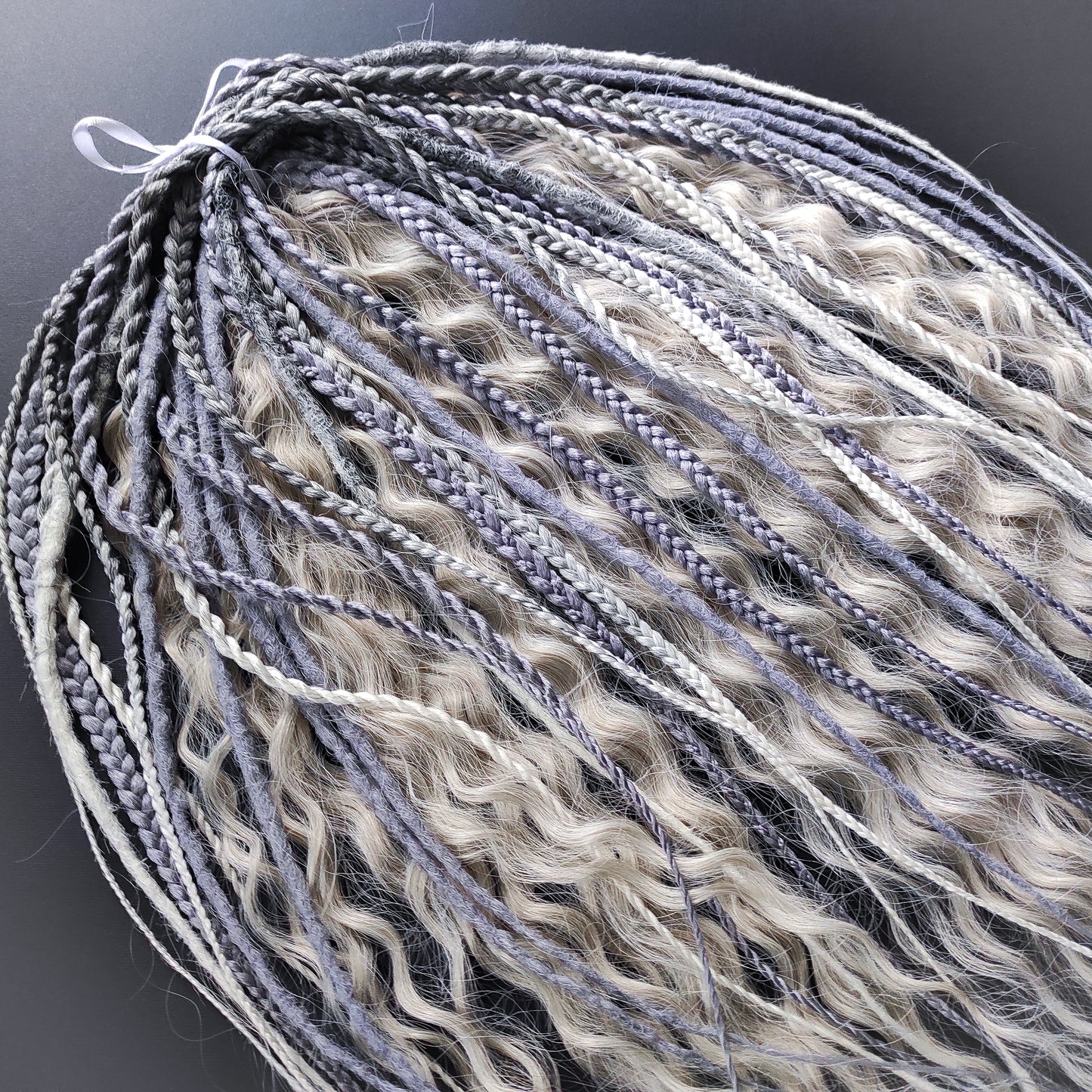 A mix of silver, grey and blonde - lightweight,  reusable synthetic double ended crochet dreadlocks, non-brushable dreaded curls, braids, and Senegalese twists.

Standard length: ±22-24 inches (55-60 cm)
Thickness of dreads and braids: ±0.8 cm
Dreaded part of curls ±10-12 cm (4-5 inches)