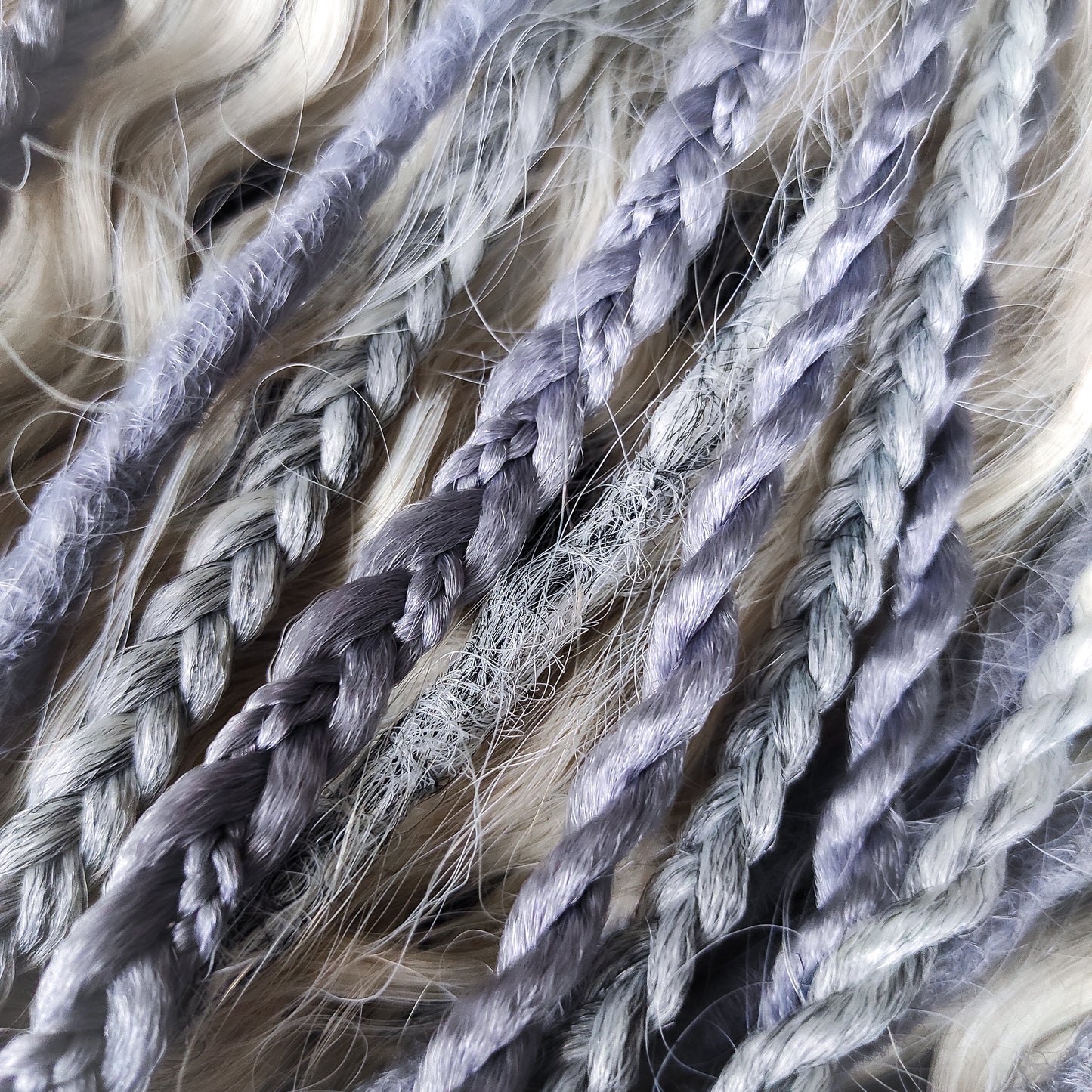 A mix of silver, grey and blonde - lightweight,  reusable synthetic double ended crochet dreadlocks, non-brushable dreaded curls, braids, and Senegalese twists.

Standard length: ±22-24 inches (55-60 cm)
Thickness of dreads and braids: ±0.8 cm
Dreaded part of curls ±10-12 cm (4-5 inches)