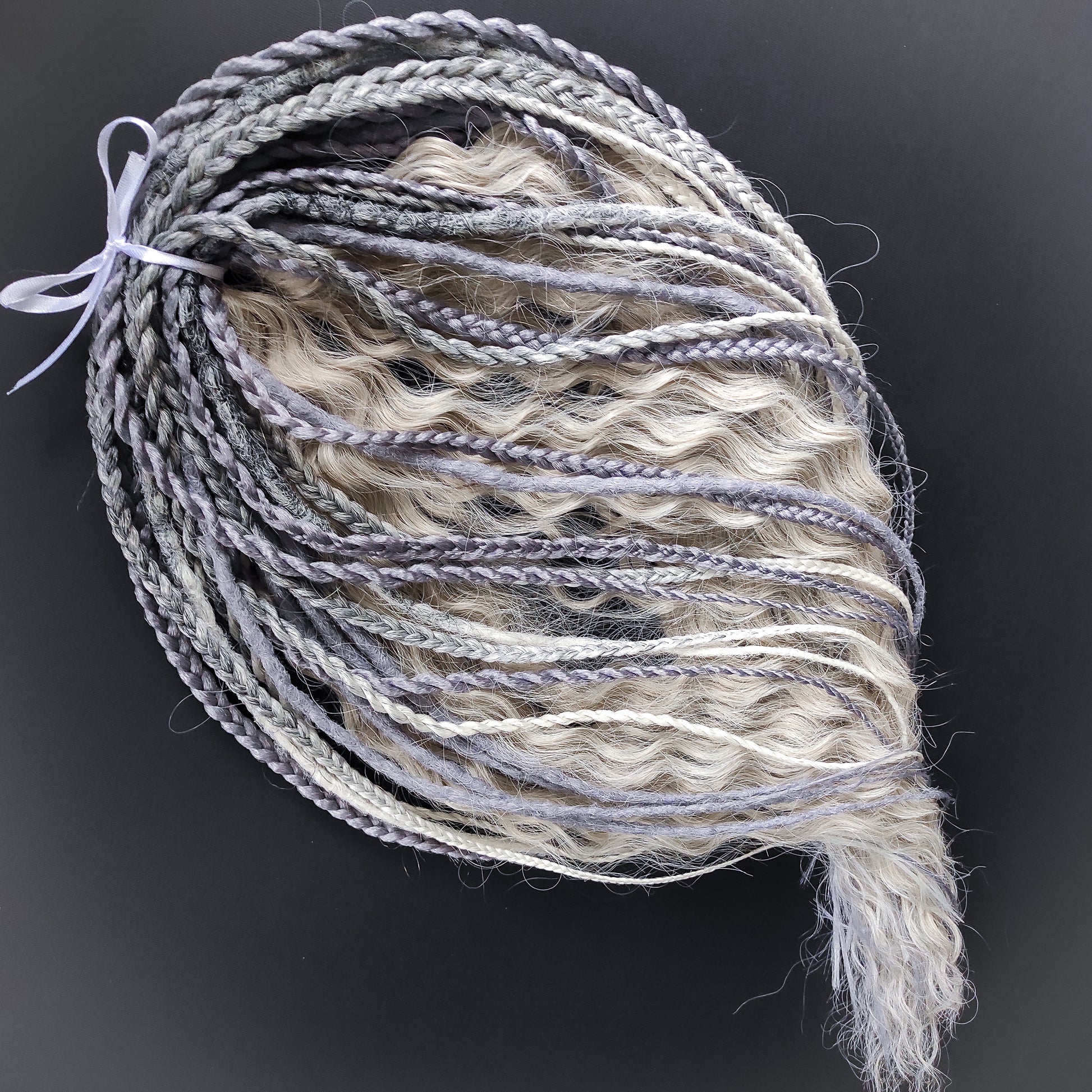 A mix of silver, grey and blonde - lightweight,  reusable synthetic double ended crochet dreadlocks, non-brushable dreaded curls, braids, and Senegalese twists.

Standard length: ±22-24 inches (55-60 cm)
Thickness of dreads and braids: ±0.8 cm
Dreaded part of curls ±10-12 cm (4-5 inches)