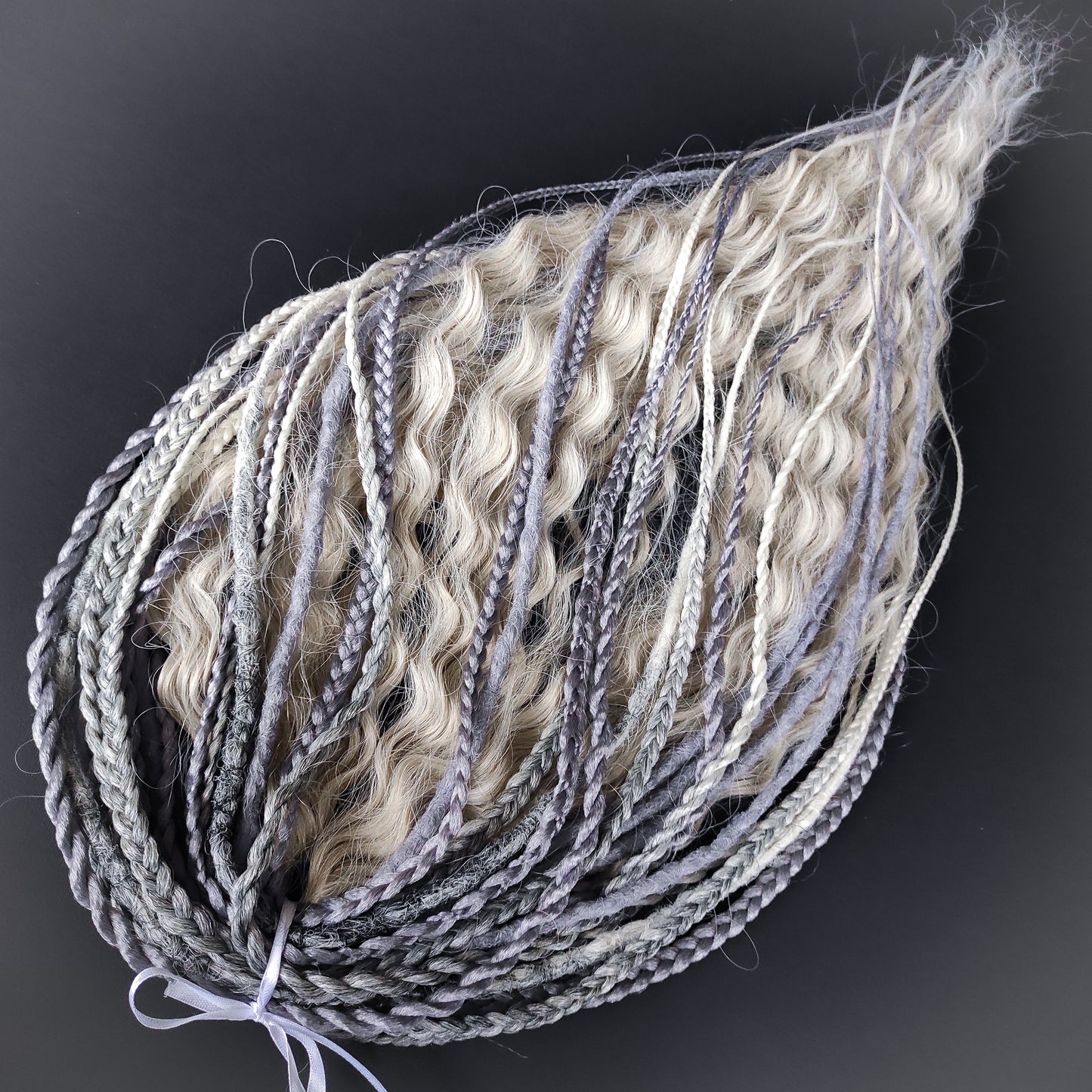 A mix of silver, grey and blonde - lightweight,  reusable synthetic double ended crochet dreadlocks, non-brushable dreaded curls, braids, and Senegalese twists.

Standard length: ±22-24 inches (55-60 cm)
Thickness of dreads and braids: ±0.8 cm
Dreaded part of curls ±10-12 cm (4-5 inches)