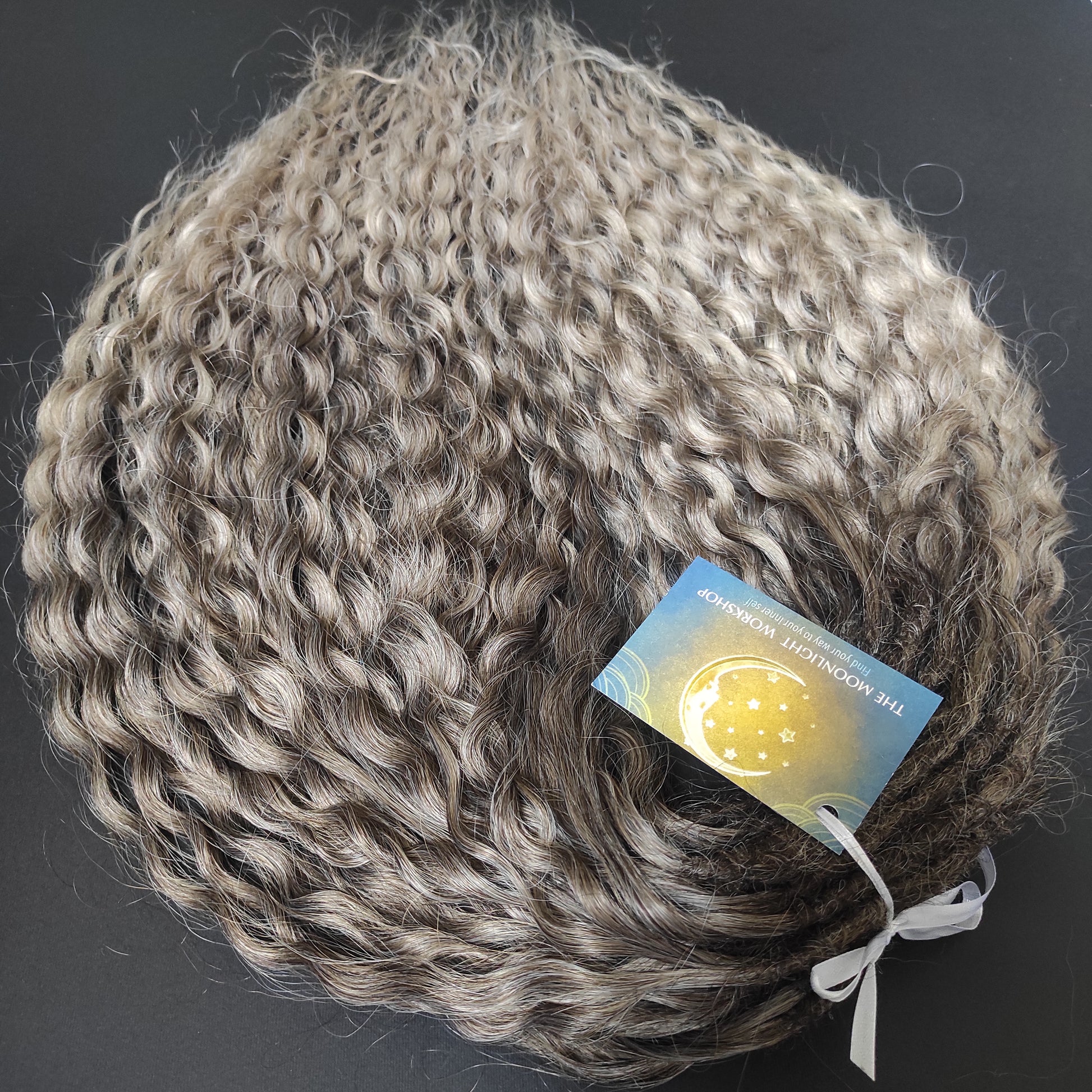 Ash ombre from light brown to wheat blonde (the color may look a bit different in different lighting). Soft, lightweight, and reusable synthetic brushable double ended wavy dreadlocks