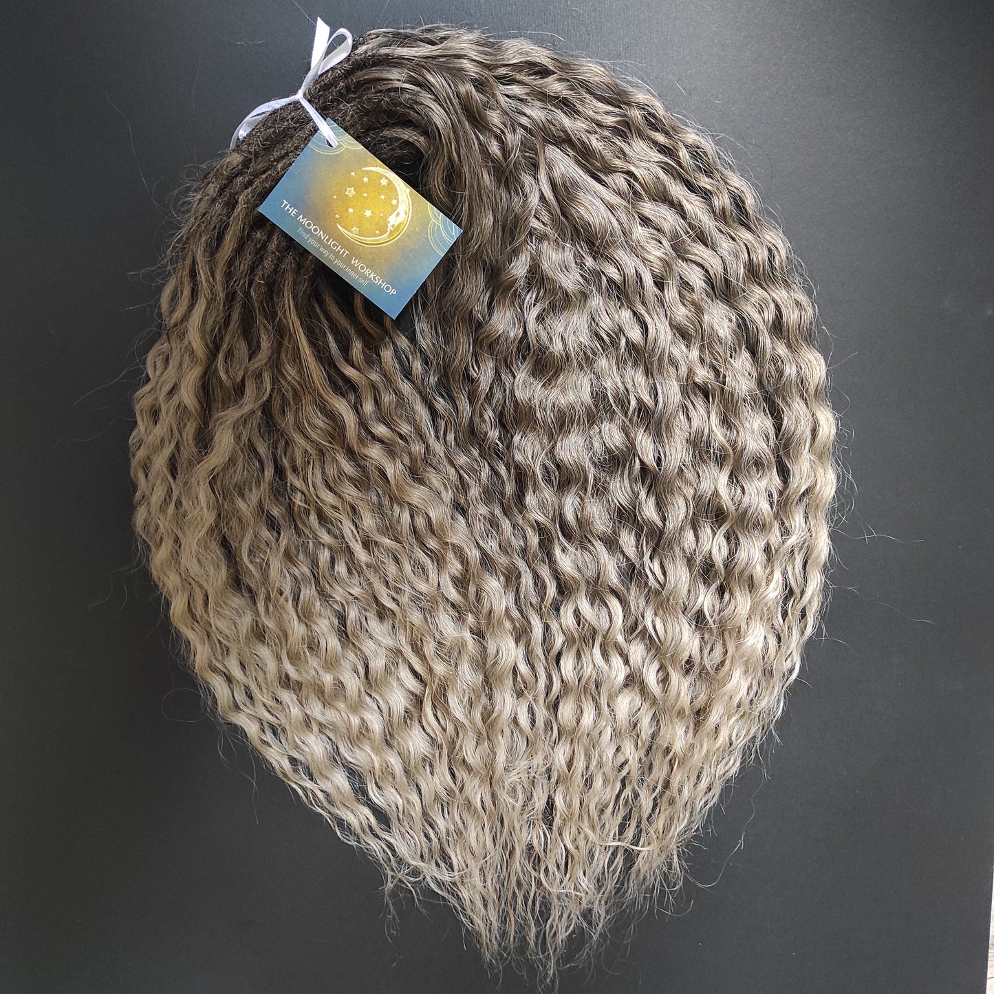 Ash ombre from light brown to wheat blonde (the color may look a bit different in different lighting). Soft, lightweight, and reusable synthetic brushable double ended wavy dreadlocks