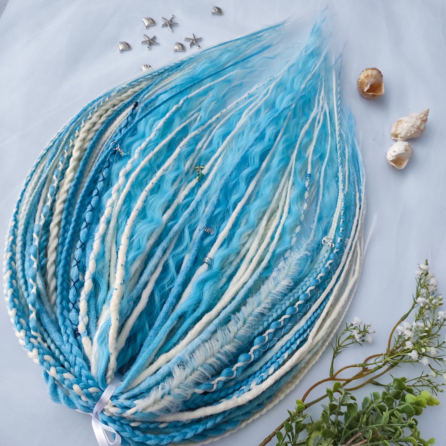 Ice Flow is a soft, lightweight, and reusable set of double ended synthetic crochet dreadlocks, various braids, and dreaded curls. A fresh blend of icy blue and soft white with a smooth, airy flow of color.

Standard length: 22-24 inches (55-60 cm)
Thickness of dreads and braids: ~0.8 cm
Dreaded part of curls ~3-4 inches (8-10 cm)
