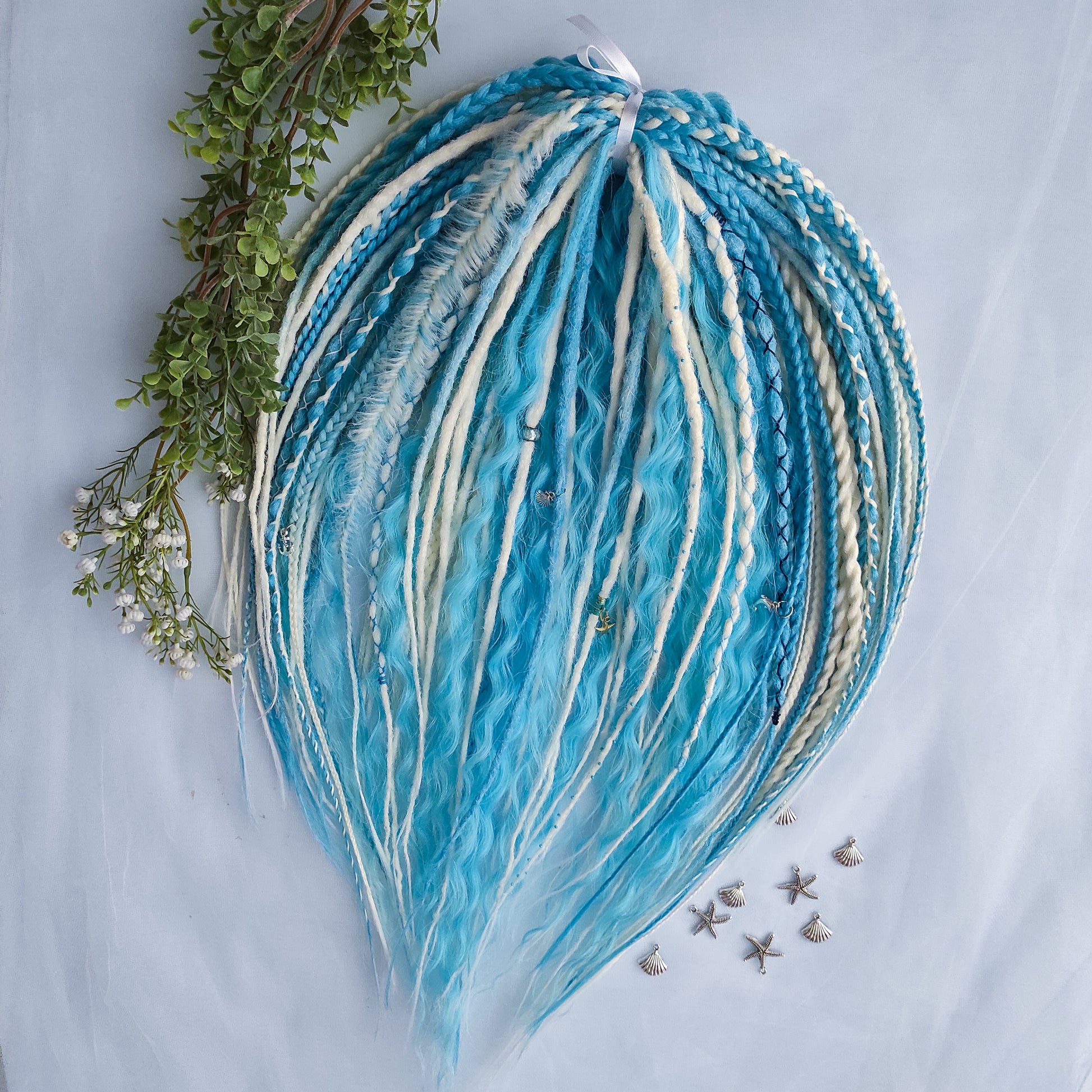Ice Flow is a soft, lightweight, and reusable set of double ended synthetic crochet dreadlocks, various braids, and dreaded curls. A fresh blend of icy blue and soft white with a smooth, airy flow of color.

Standard length: 22-24 inches (55-60 cm)
Thickness of dreads and braids: ~0.8 cm
Dreaded part of curls ~3-4 inches (8-10 cm)