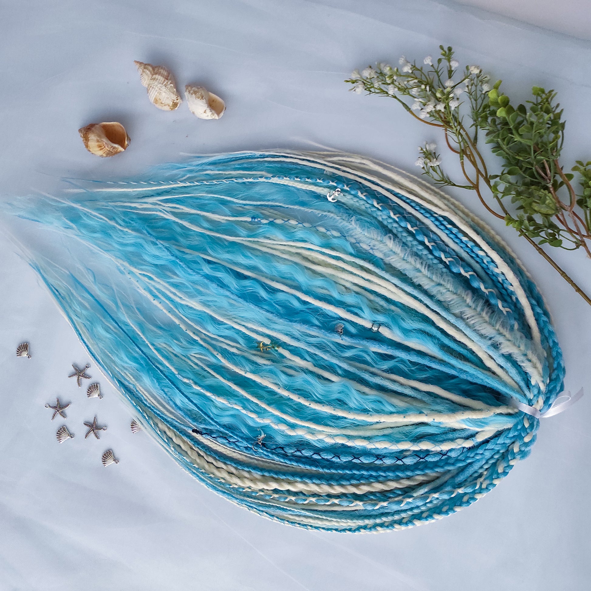 Ice Flow is a soft, lightweight, and reusable set of double ended synthetic crochet dreadlocks, various braids, and dreaded curls. A fresh blend of icy blue and soft white with a smooth, airy flow of color.

Standard length: 22-24 inches (55-60 cm)
Thickness of dreads and braids: ~0.8 cm
Dreaded part of curls ~3-4 inches (8-10 cm)