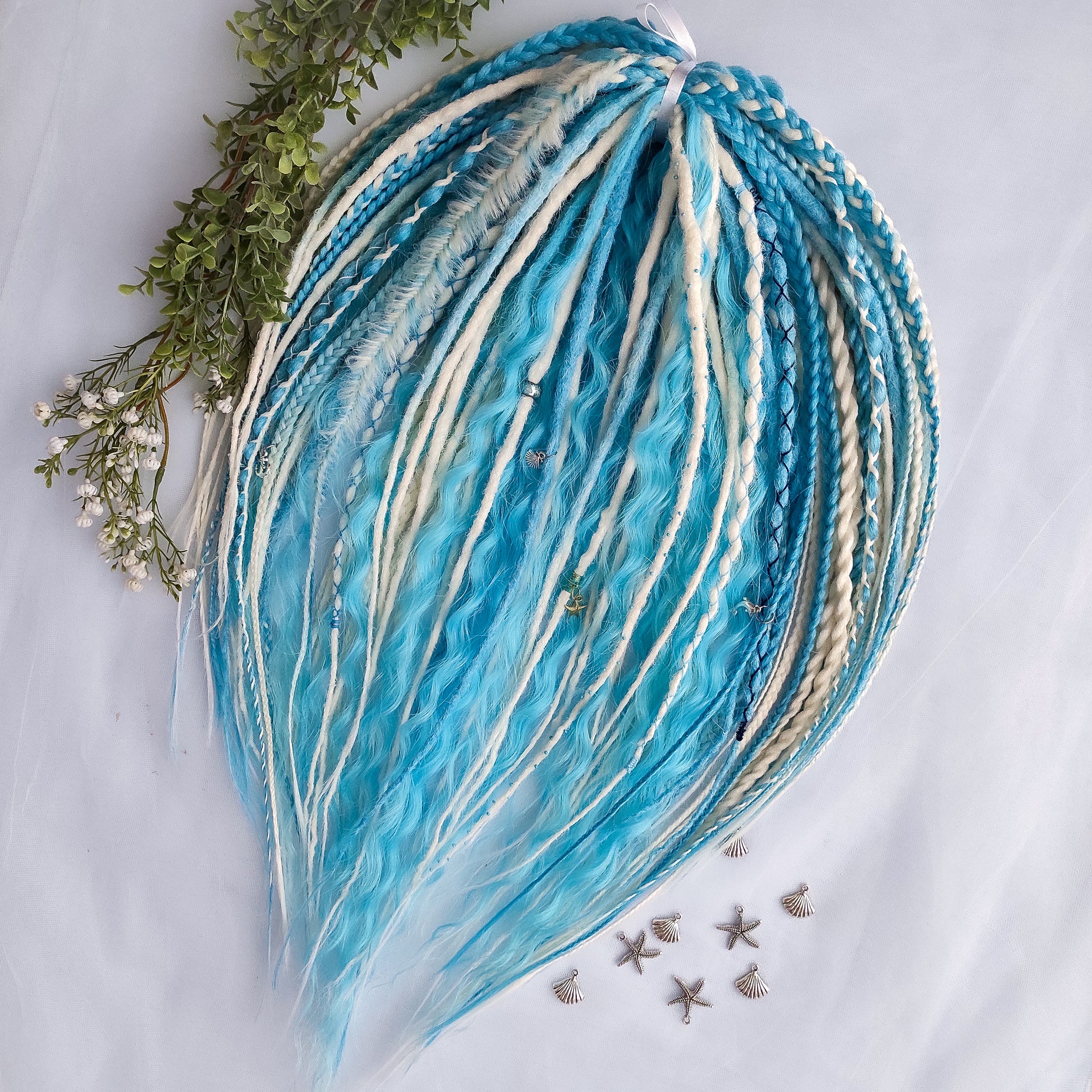 Ice Flow is a soft, lightweight, and reusable set of double ended synthetic crochet dreadlocks, various braids, and dreaded curls. A fresh blend of icy blue and soft white with a smooth, airy flow of color.

Standard length: 22-24 inches (55-60 cm)
Thickness of dreads and braids: ~0.8 cm
Dreaded part of curls ~3-4 inches (8-10 cm)