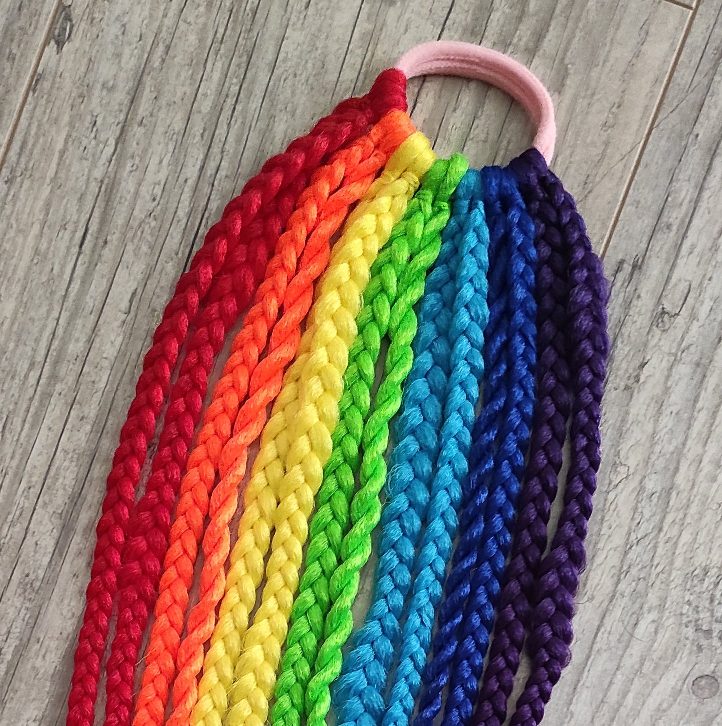 Braids, dreads, and curls on an elastic band — a simple way to transform a ponytail without installing a set. Easy to put on and remove whenever you like. A great option if you can’t install dreads or braids. Also, a perfect gift for kids 🎁

These scrunchies add instant length, volume, and texture — whether you prefer bold colors or natural shades.

Length: 22–24 inches.
Each hair tie includes 12–14 pieces, depending on the style.

Choose from the available designs shown, or contact us for a custom order.